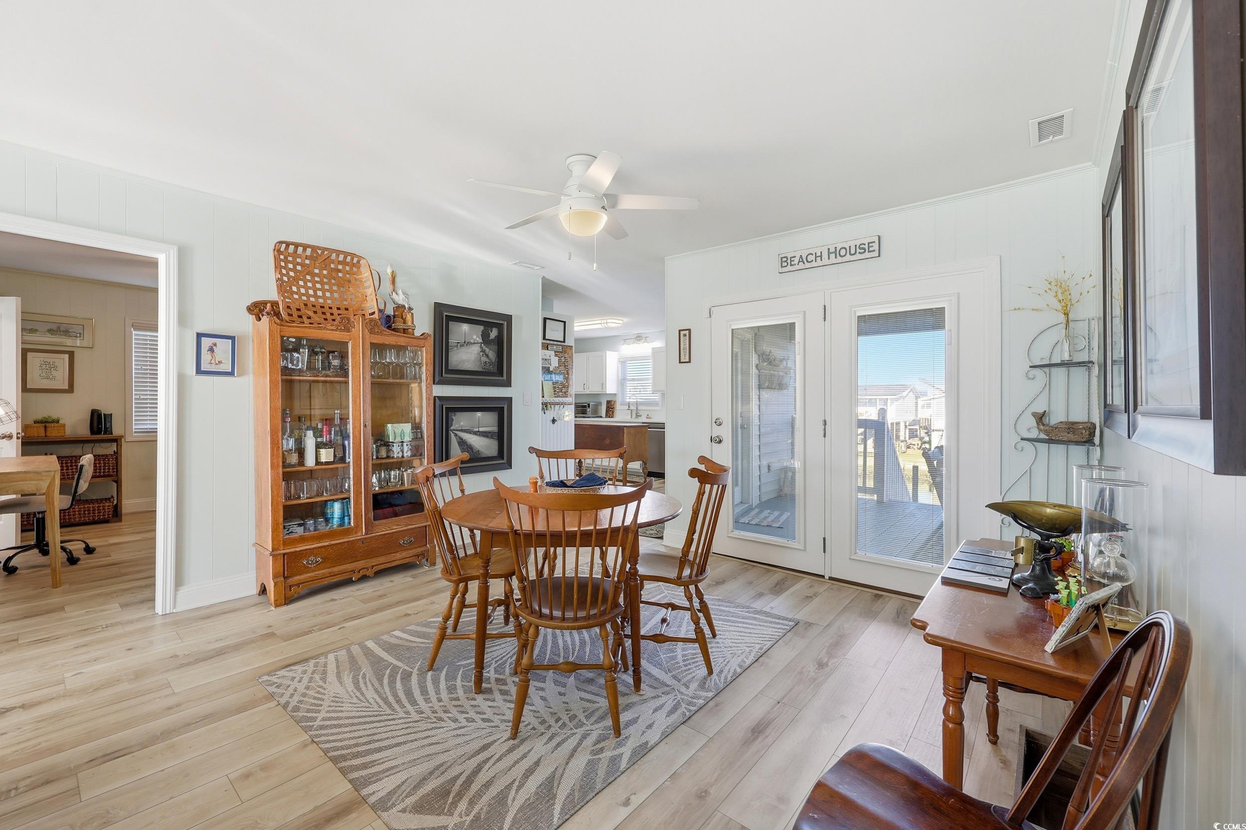 Dining space featuring light wood-type flooring and ceiling fan