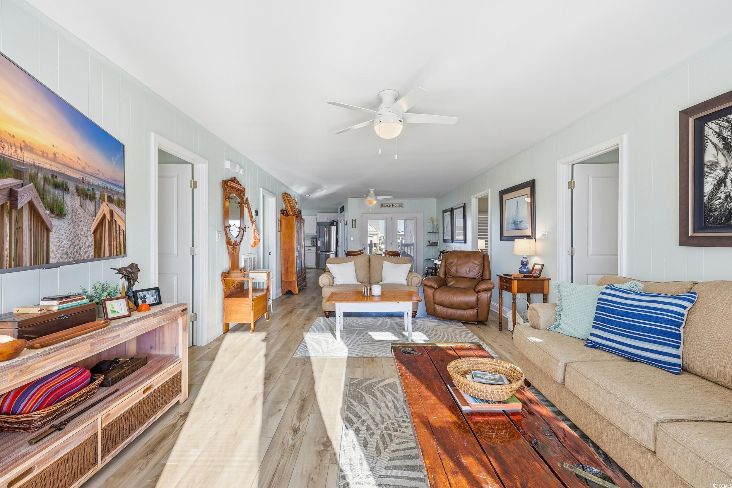 Living room featuring a ceiling fan and wood finished floors