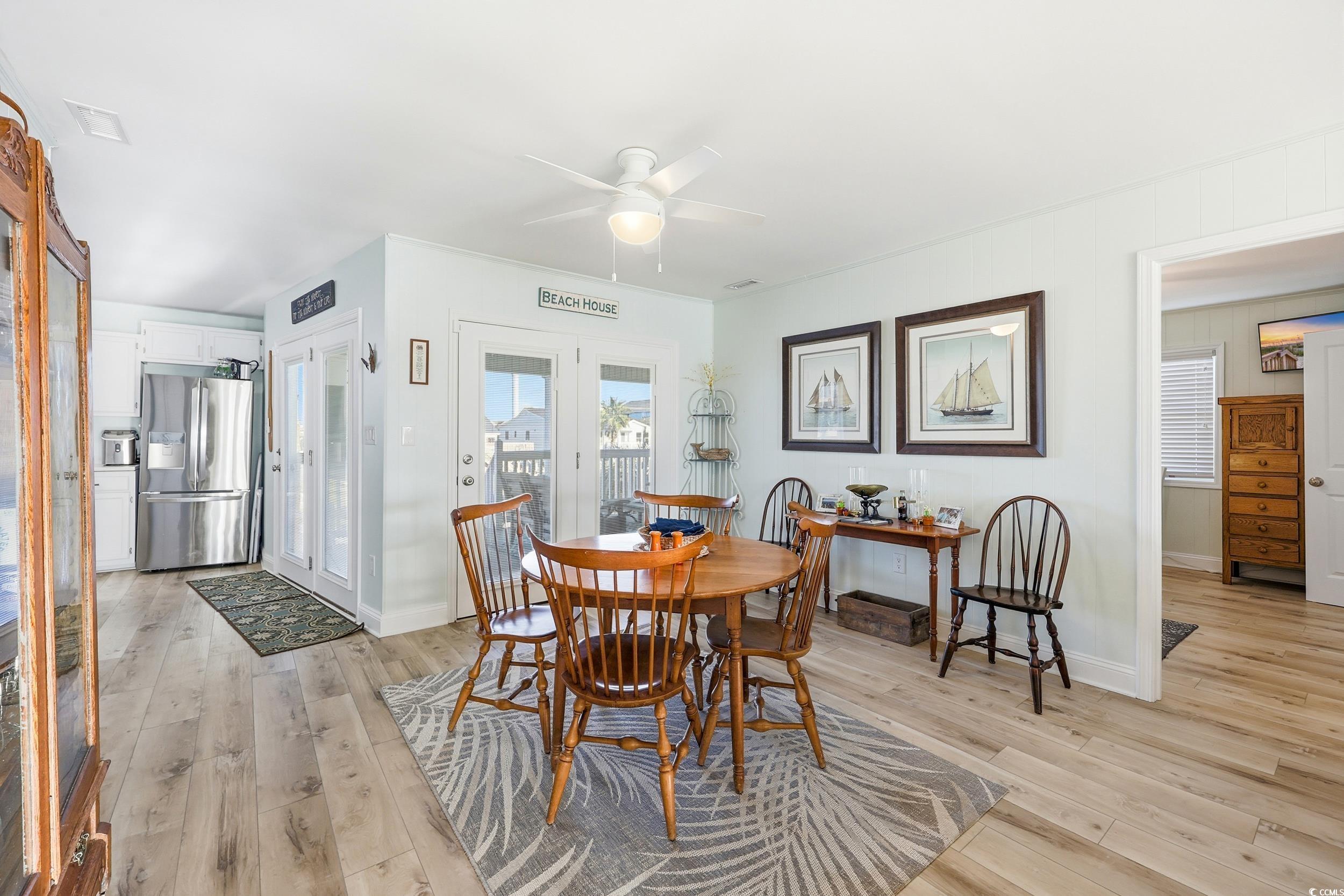 Dining space featuring light wood finished floors and a ceiling fan