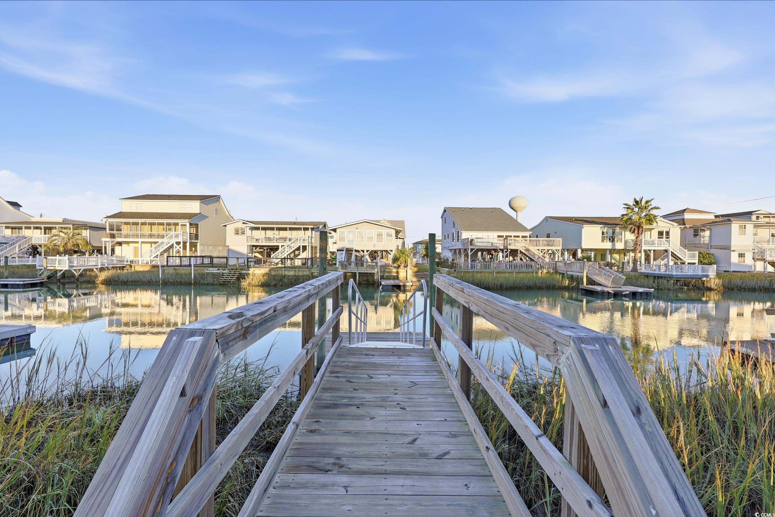 Dock with a residential view and a water view
