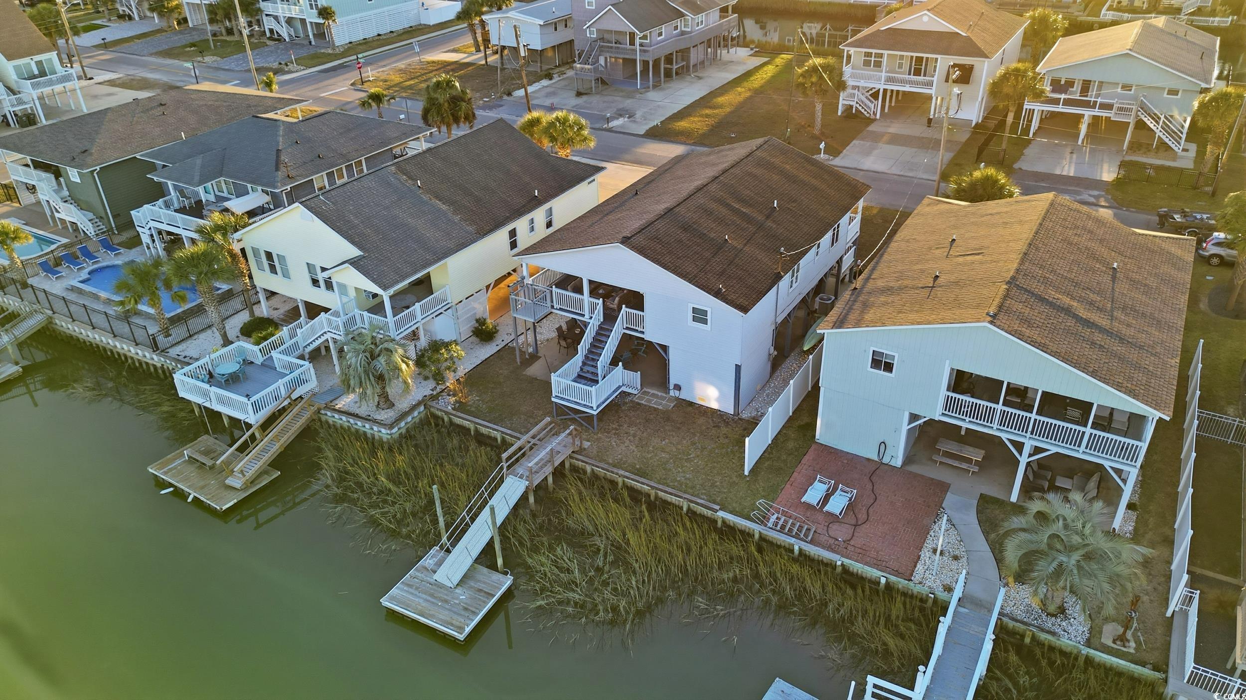 Aerial perspective of suburban area featuring a large body of water