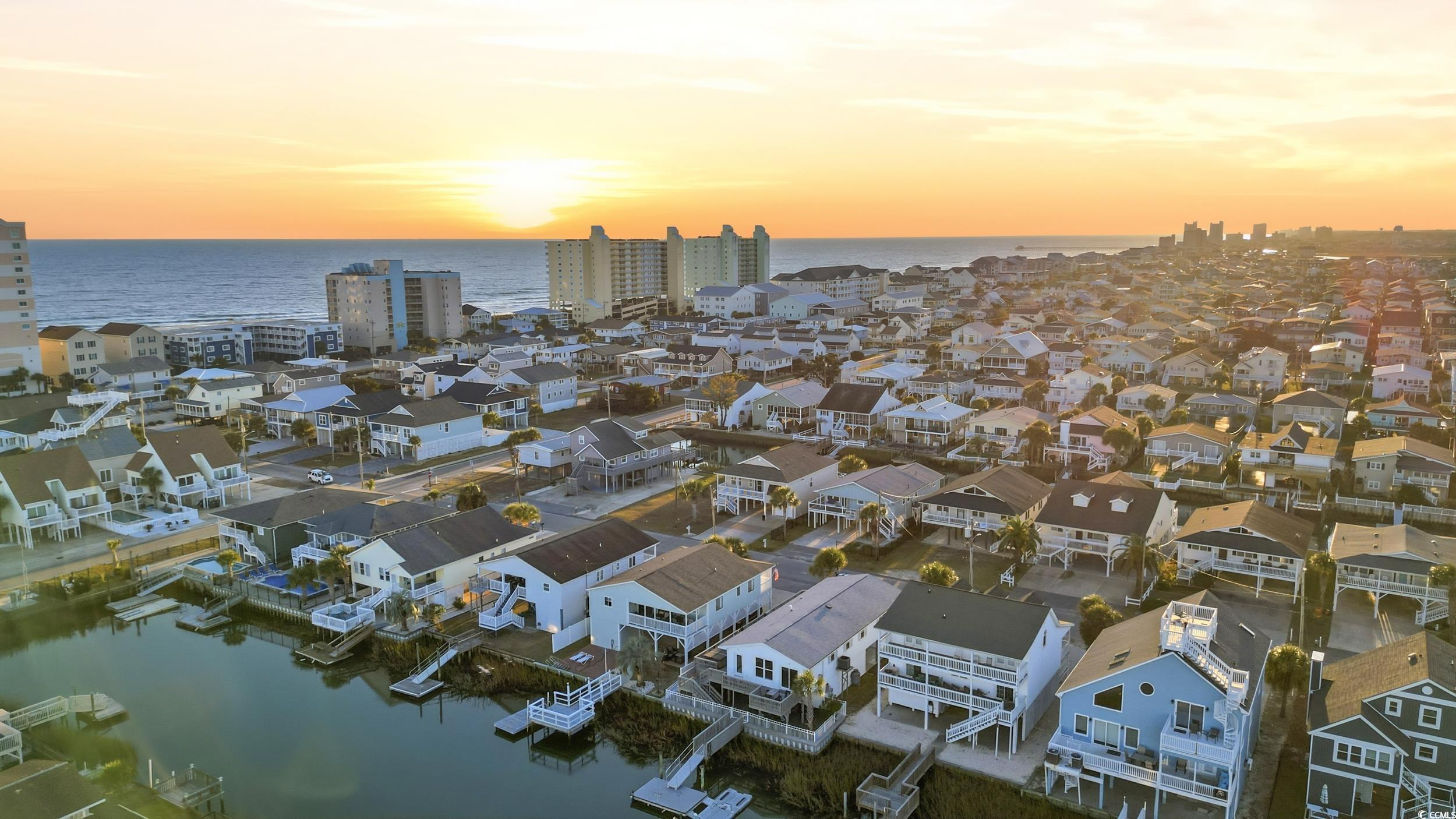 Aerial view of residential area featuring a large body of water