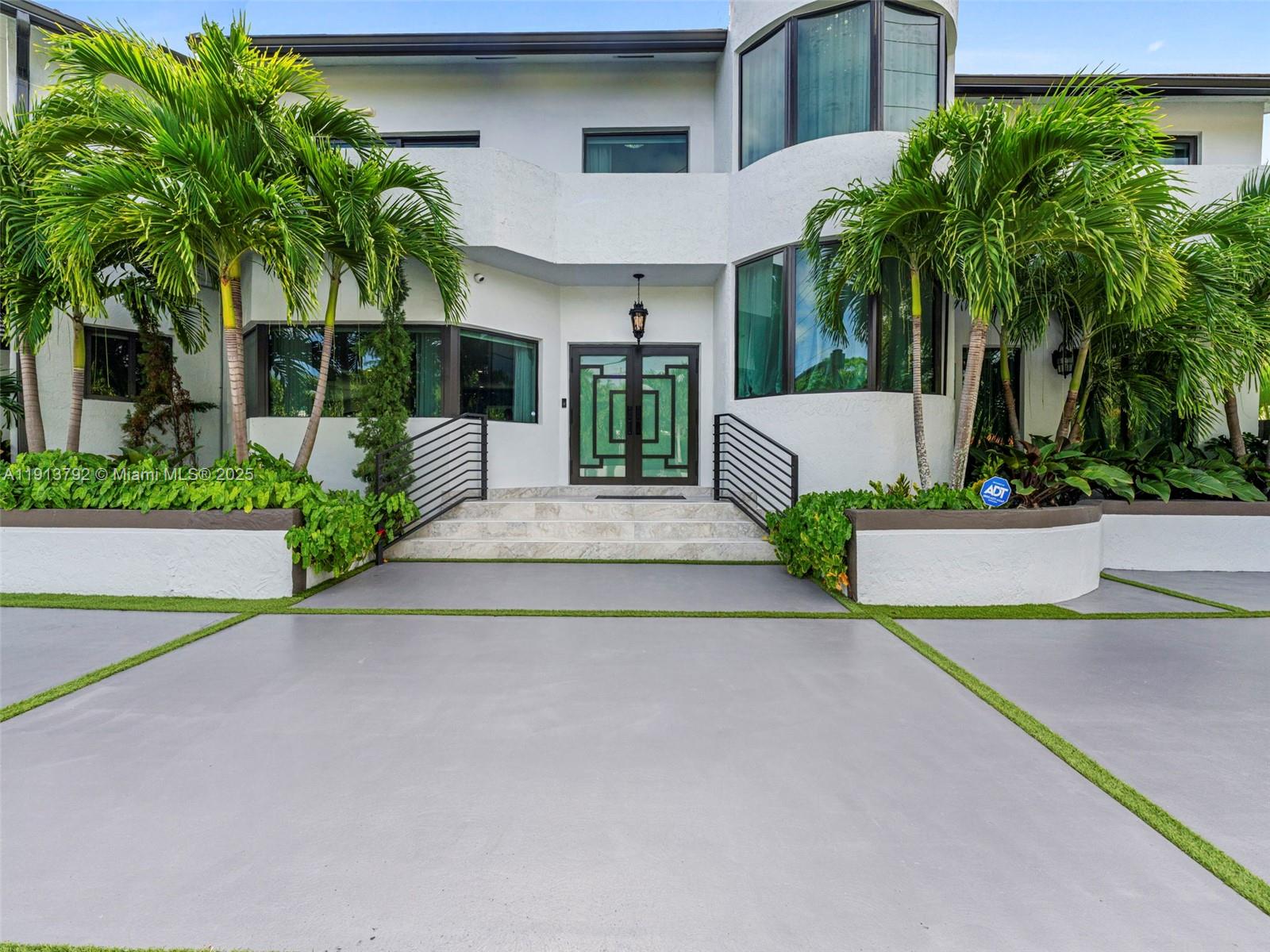 Welcome to this Hamptons-inspired residence located in the heart of Miami Beach. Set on an impressive 12,772 SF lot along exclusive Pine Tree Drive, this 1990-built home combines classic style with contemporary updates. Upon entering, you’re greeted by soaring ceilings and bright, airy interiors that exude warmth and elegance. Spacious living areas on the main level offer flexibility for both relaxing and entertaining. The upstairs primary suite features a generous layout with a large spa-like bathroom, walk-in closet, and a private office nook. Outside, experience the best of Miami living with a resort-style backyard designed for gatherings and outdoor enjoyment. The property also includes a two-car garage and a driveway with space for up to five additional vehicles.