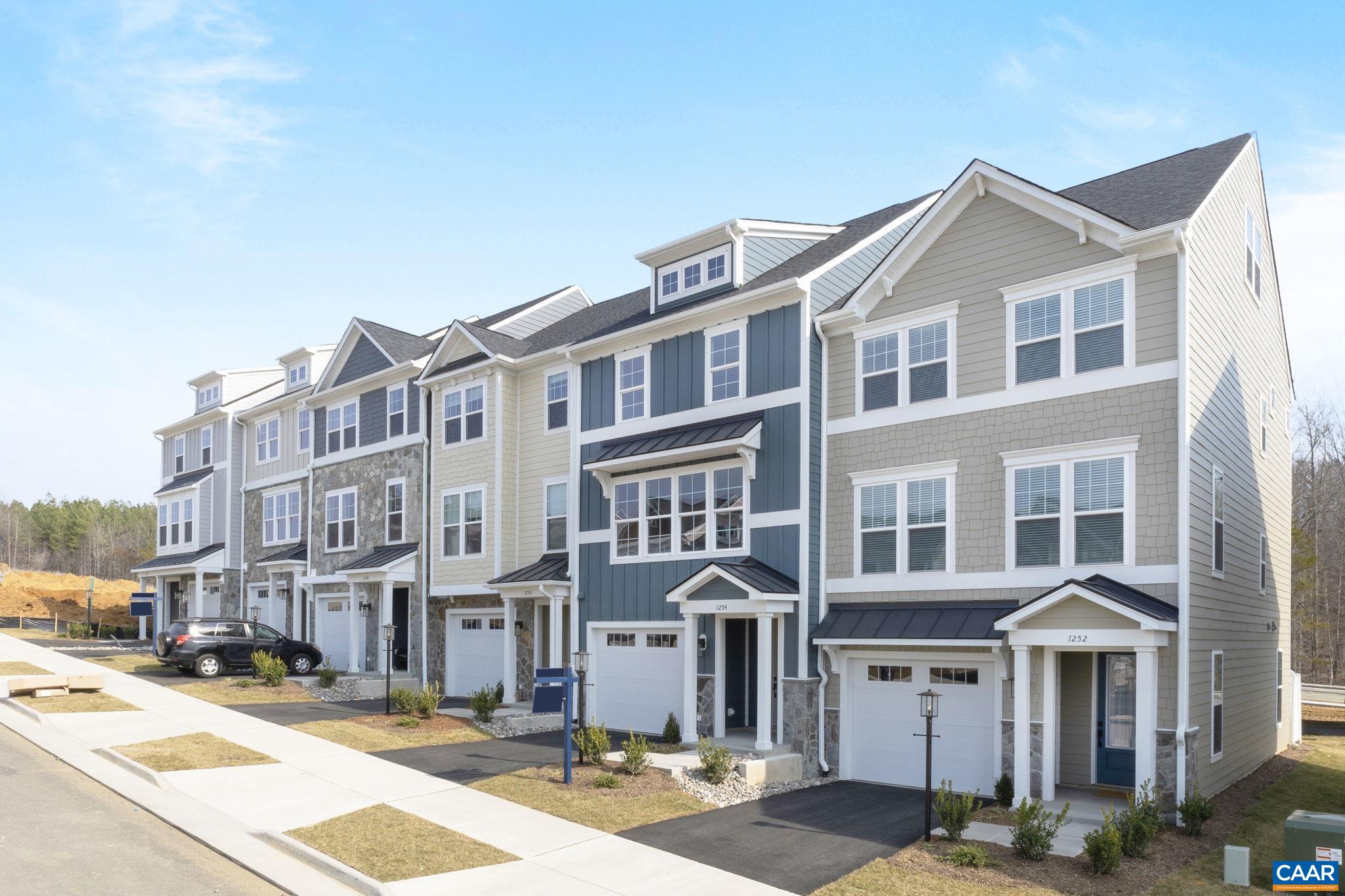 Meet the Holly I, a three-story townhome currently under construction with an expected completion in October. Located in the newest section of Belvedere, this home begins with a flexible rec room and half bath on the main level. It works well as a workspace, home gym, or bonus hangout area. The second floor features a spacious kitchen with a walk-in pantry, a comfortable dining area, and a bright family room. Just off the main living space, a screened-in porch makes it easy to enjoy the outdoors. There is an additional half bath on this floor as well. Upstairs, the primary suite includes a private bathroom, while two additional bedrooms share a full hall bath. The laundry room is also located on the third floor for added convenience. Oak stairs with open railings provide a clean and modern finish. The one-car garage offers parking and extra storage. The Rivanna Trail runs through the wooded area just behind the home, providing easy access to scenic walks and nature. Actual photos coming soon! Photos shown are of a similar home and may include optional or upgraded features.