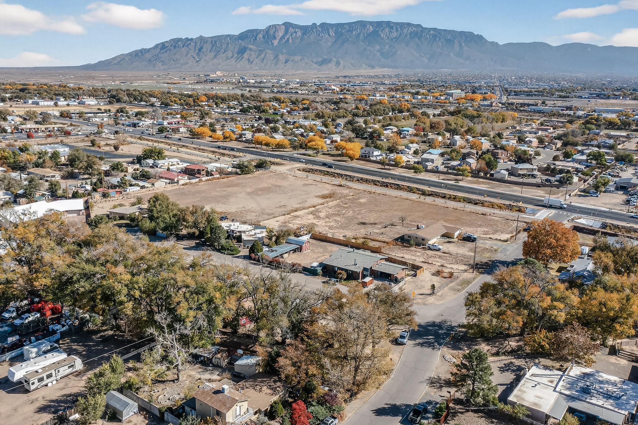 Extraordinary Opportunity for 4.12 acres of mostly clear land with VIEWS of mountains and hot air balloons!!  Super Convenient  location in the highly sought-after North Valley off 2nd St, between Alameda & Paseo del Norte!  Over 180,000 square feet - huge potential, this property is a blank canvas just waiting for your creative touch. Currently zoned R-1 with public utilities already connected to the property via an existing 1700sqft home at the Southwest corner of the land. Imagine subdividing, building, or developing --be it a stunning residential community, or an exclusive enclave of luxury homes. This location has  convenient access and unbeatable flexibility- near shops, restaurants and freeway access.  Developers will want to investigate the feasibility of re-zoning.