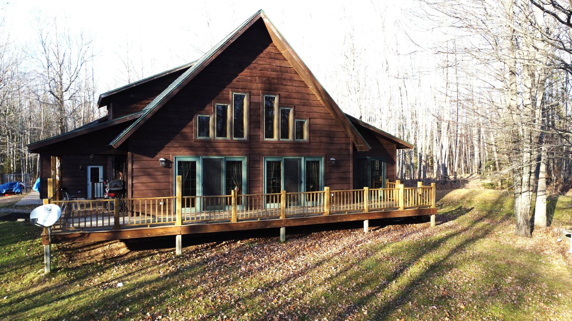 Escape to your own piece of heaven with 19 acres of pristine land and a charming 2-story, 1950 sq. ft. home. This beautifully designed retreat features 2 bedrooms, 2 bathrooms, and a spacious loft overlooking the dining, family areas and sunroom. The open-concept floor plan exudes a cabin feel with a striking cultured stone fireplace and breathtaking knotty pine ceilings with a dramatic 12/12 pitch. The unfinished basement with 9-foot walls is ready for expansion, with roughed-in plumbing for an additional bathroom and extra living space. Outdoor enthusiasts will love the snowmobile and UTV trails right on the property, offering year-round adventure. Perfect for those who seek privacy, nature, and the ultimate escape, this home combines rustic charm with room to grow. Call today to schedule an appointment. All data approximate, Buyer to verify all information