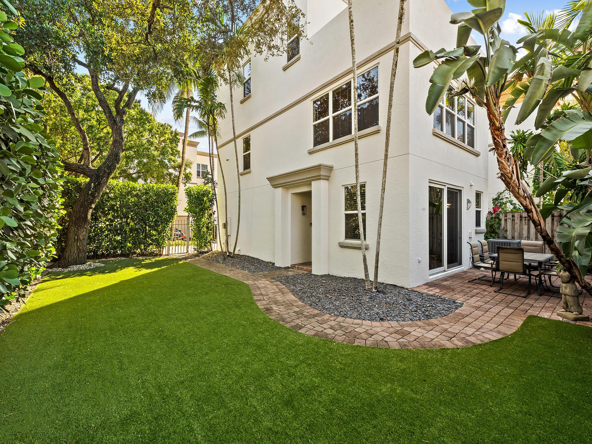 A 3-story townhome with 2-car garage located in Tarpon River, just minutes from Downtown Fort Lauderdale and the beach in a gated community with a pool. This home offers plenty of entertaining space including a spacious yard with turf grass and 3rd-floor patio balcony overlooking downtown. The first floor features a bedroom with french doors to direct yard access and a full bathroom. The main level opens to a bright living dining area with a half bath and your kitchen with white shaker cabinets and stainless appliances. The top floor is a private primary suite with access to the patio balcony, a large custom closet, dual-sink bath, walk-in shower, jacuzzi tub. This freshly painted, move-in ready townhome the delivers the best of Tarpon River living in an unbeatable location.