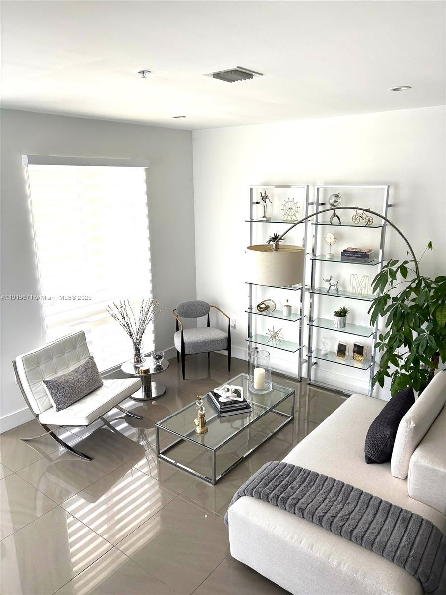 Beautiful and bright 3-story corner townhome in Landmark at Doral featuring 3 bedrooms, 2.5 baths, and a family room. Designed for comfortable living with high ceilings, ceramic tile floors on the first floor, and carpeted bedrooms upstairs. The spacious primary suite includes remote-controlled shades. Enjoy a modern kitchen with quartz countertops, touchless faucet, and stainless steel appliances. 1-car garage, great location near schools, parks, shopping, and Turnpike.