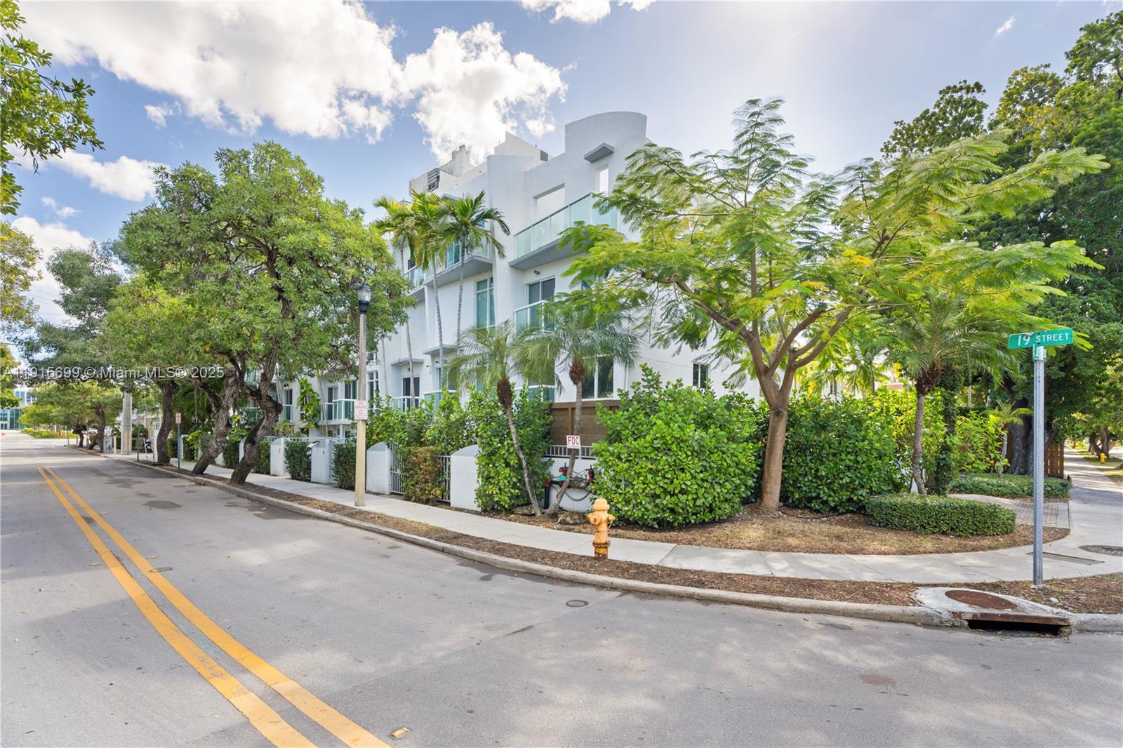 Nestled in a prime Miami Beach neighborhood, this three-bedroom townhouse offers exceptional privacy on one of the area’s most tranquil, tree-lined streets. Its location places you within easy walking distance of Lincoln Road, Sunset Harbour, and Miami Beach.The home features soaring volume ceilings that fill the space with natural light, along with impeccable finishes throughout. Quartz countertops, designer wallpaper, custom mirrors, and porcelain tile create a luxurious, modern aesthetic. An exclusive outdoor area is perfect for entertaining guests and further enhances the appeal of this elegant residence.