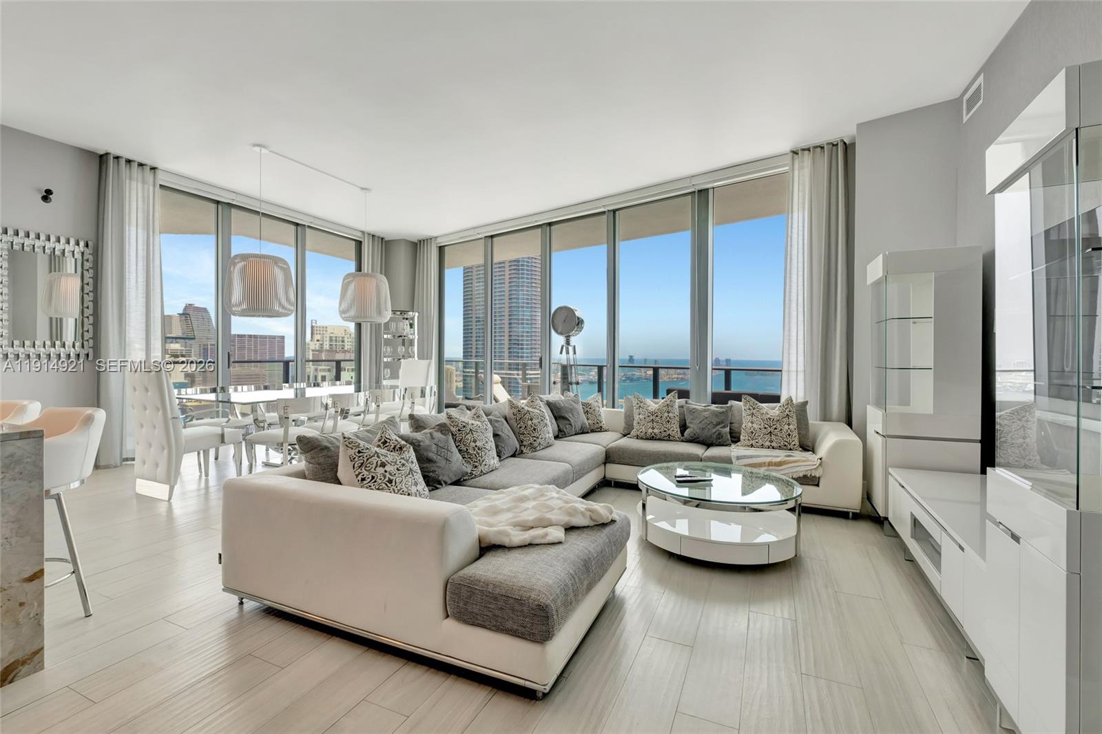 $400K PRICE REDUCTION!Experience elevated living in this spacious northeast corner penthouse offering breathtaking panoramic views of Biscayne Bay, Key Biscayne, Miami Beach, and the dazzling Brickell skyline. Enjoy spectacular city lights by night from a prime vantage point high above it all. This residence features 3 bedrooms with ensuite baths, a den/office, and a guest powder room. Soaring high-volume ceilings and a generous wraparound balcony create an open, airy atmosphere, with multiple access points through high-impact sliding glass doors. The expansive primary suite includes a luxurious bathroom with separate soaking tub, oversized shower, dual vanities, and a walk-in closet. The home is equipped with flat-screen TVs throughout, Bose surround sound, and motorized solar and blackout shades for ultimate comfort and convenience.  Additional highlights include two assigned parking spaces and high-speed internet included. Residents enjoy exclusive access to Dua Miami’s luxury amenities, including a spa and residents-only rooftop pool.