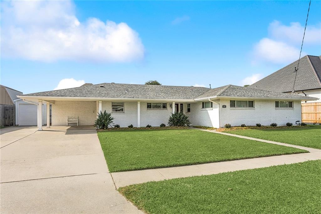 This charming single-story ranch home offers exceptional curb appeal with its clean white brick exterior, wide frontage on a large lot and a spacious covered carport. The manicured lawn and simple, modern landscaping set a welcoming tone as you approach the front entrance. Inside the home features an open concept layout filled with natural light featuring 4 bedrooms and 3 1/2 baths. The main living area showcases warm hardwood floors, recessed lighting, and a fresh neutral color palette that makes the space feel bright and inviting. Large windows and French doors provide backyard views and easy indoor-outdoor flow, great for relaxing or entertaining. The living room is generously sized and allows a seamless transition into the dining and kitchen spaces, giving the home an airy, uninterrupted feel. The layout is great for gatherings and everyday living. Step into this bright, modern kitchen featuring crisp white cabinetry, stainless steel appliances, granite countertops, recessed lighting, and a spacious layout great for cooking and entertaining. The open design flows seamlessly toward the backyard, where a large covered patio awaits. Beyond the patio, enjoy your own private oasis. The sparkling in-ground pool with elevated spa and expansive pool deck offers everything needed for outdoor entertaining. The fully fenced yard provides privacy, while additional seating areas, grass area and a large detached game-room or cabana (22.2x20.4) with a half bath.  There is also a separate garage for easy storage. This home combines comfort, style, and exceptional outdoor living.