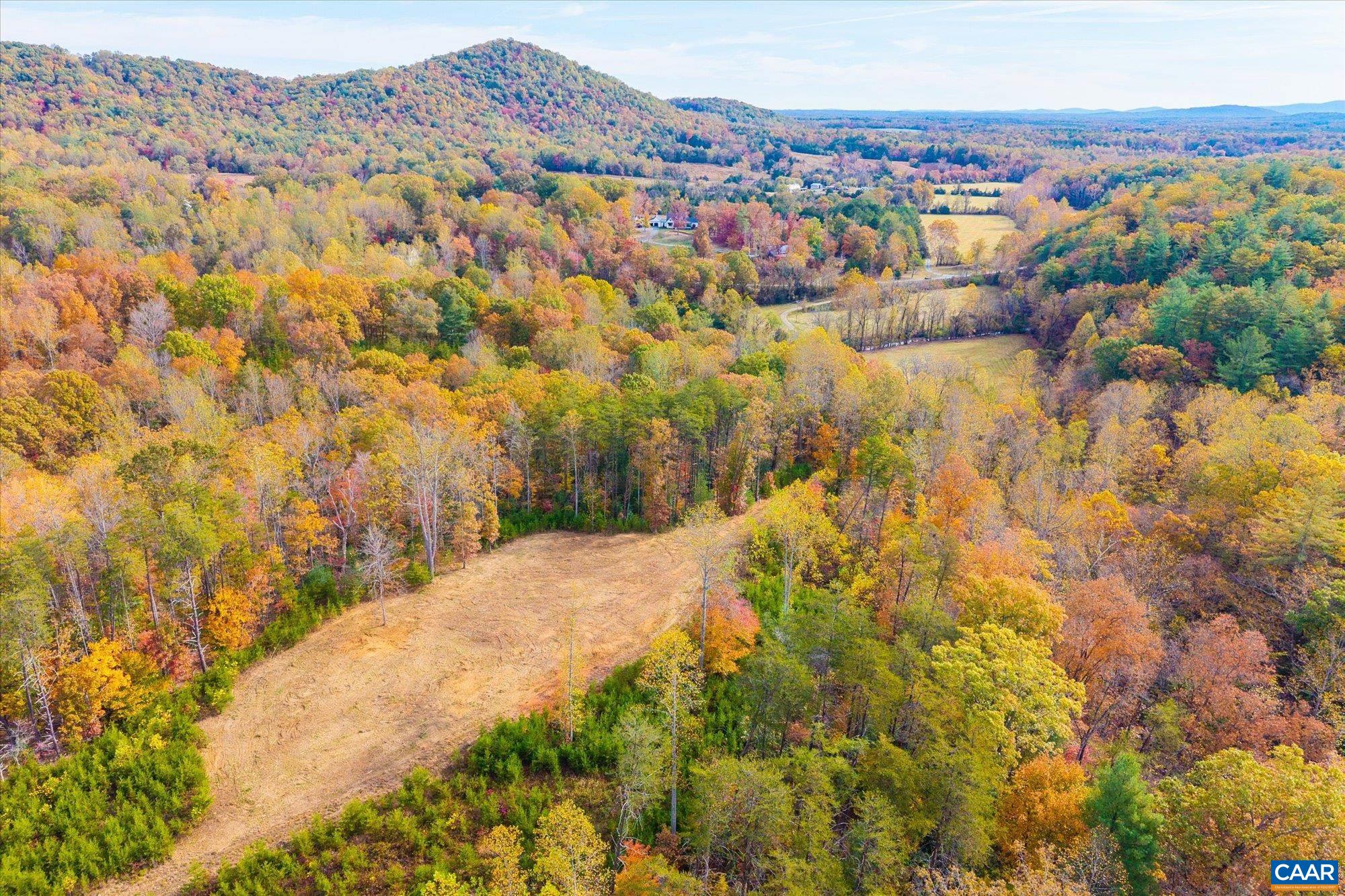 Exceptional 34-acre estate parcel in the hills of Free Union, featuring gorgeous frontage on Buck Mountain Creek. This rare offering combines open bottomland, giant rock outcroppings, wooded hillsides, and a magnificent elevated homesite that features sweeping panoramic views in multiple directions. An idyllic winding entrance from Free Union Road crosses a recently rebuilt stone bridge, leading gently up to the cleared and level building site—the perfect setting for your dream home or retreat. Existing trails around the property lead to secondary building areas and offer potential for ATV or mountain biking. The stone fireplaces and existing spring from an old cabin create a charming riverside pavilion area. This property is ready for development, with underground power, fiber-optic internet available, and previous soil studies on file. Its location offers the best of both privacy and convenience: only 20 minutes from UVA and downtown Charlottesville, with easy access to Route 29 North and nearby shopping and dining. Large parcels with this combination of natural beauty & accessibility, are exceptionally rare in the Western Albemarle / Ivy Elementary district. Theoretical division rights (to be confirmed with the county).