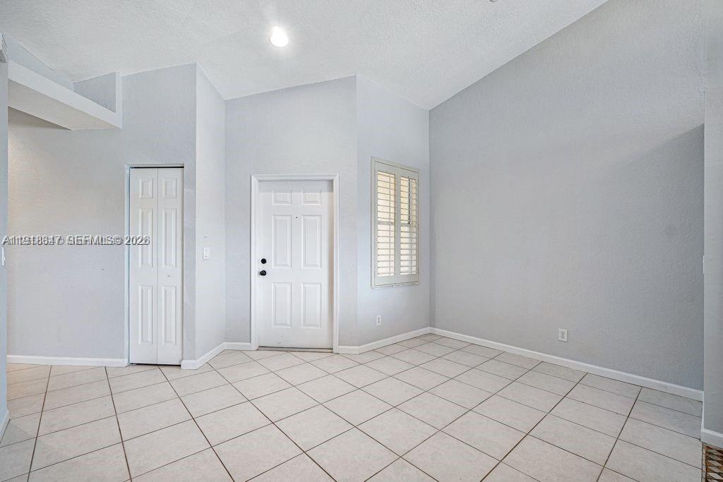 Spacious living room with panoramic views at 2437 Coral Trace Cir - Townhouse in Delray Beach