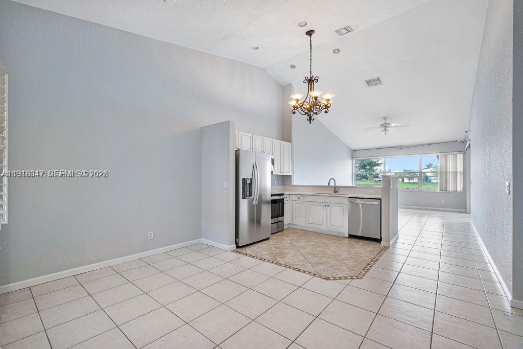 Modern kitchen with designer features at 2437 Coral Trace Cir - Townhouse in Delray Beach