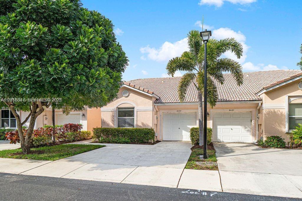 Spacious living room with panoramic views at 2437 Coral Trace Cir - Townhouse in Delray Beach