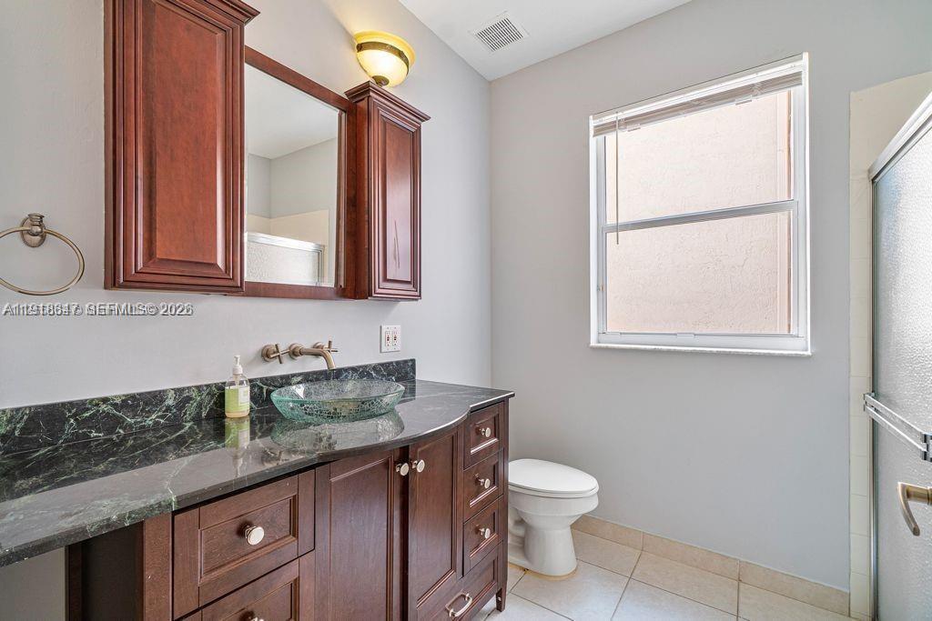 Modern kitchen with designer features at 2437 Coral Trace Cir - Townhouse in Delray Beach