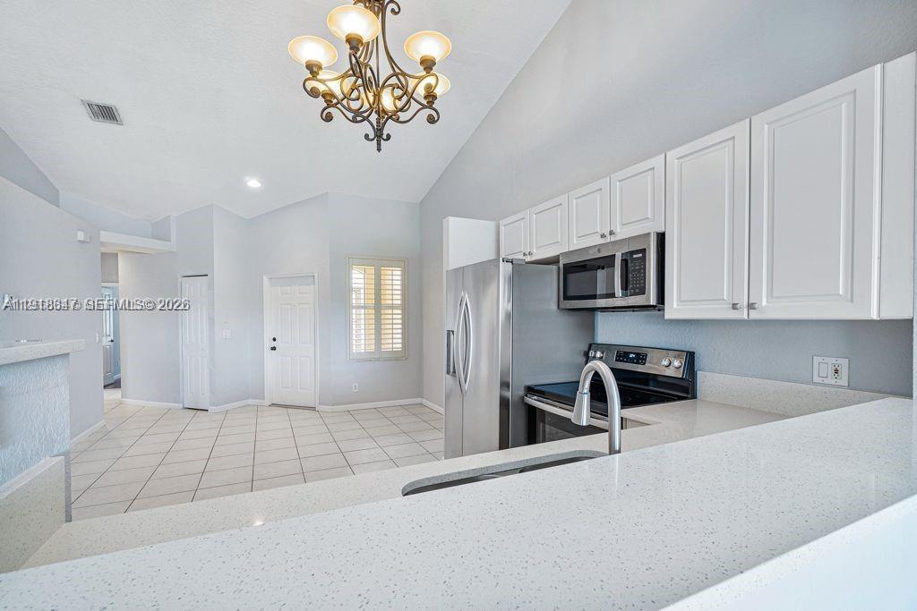Elegant master bedroom retreat at 2437 Coral Trace Cir - Townhouse in Delray Beach