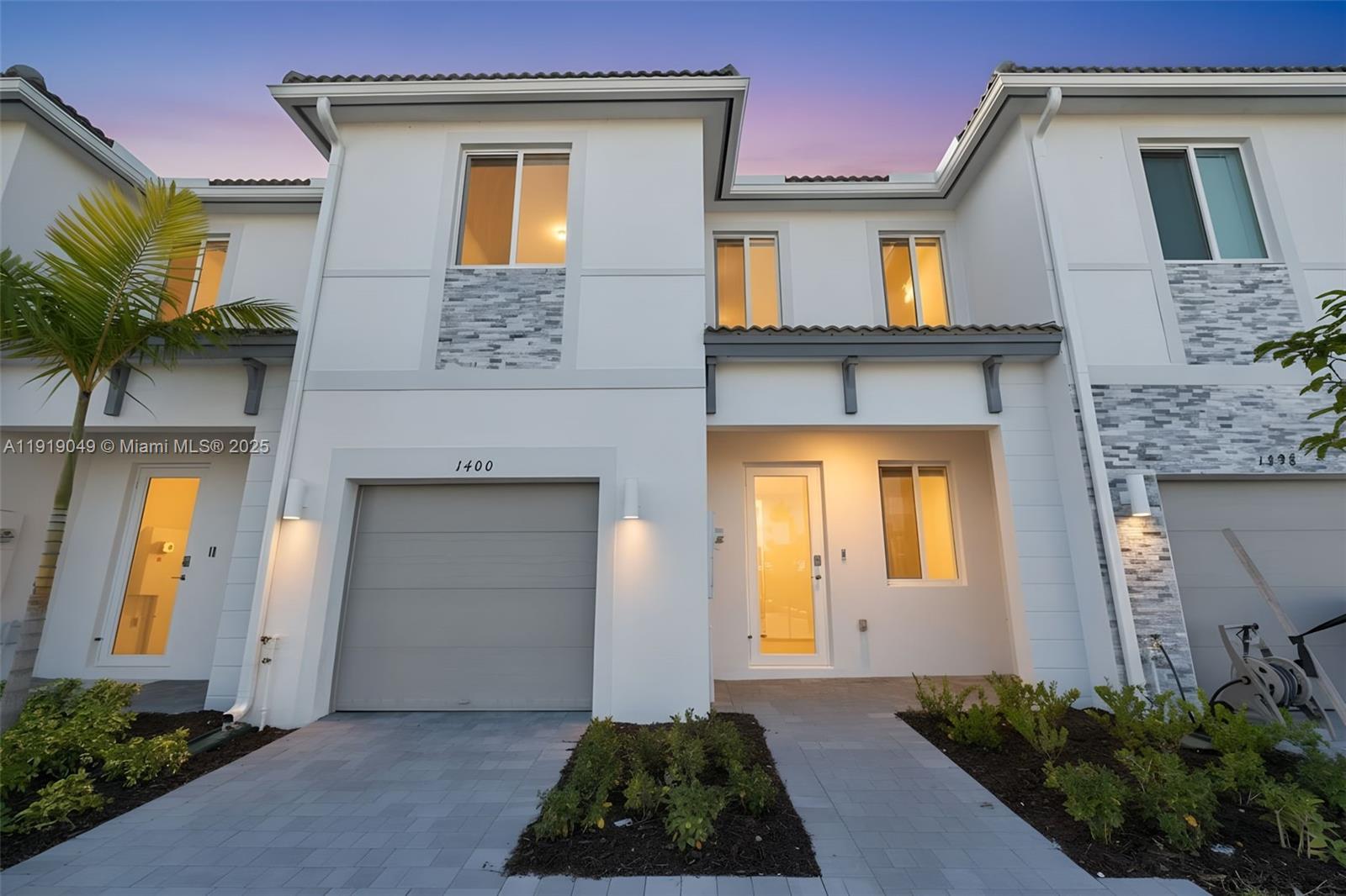 NO CARPET! This contemporary  Move in ready two-story townhome offers a thoughtfully designed layout with a 1-car garage plus two additional driveway spaces, a private patio, and an inviting open-concept living area. The kitchen showcases quartz countertops, brand-new stainless steel appliances, Italian-style cabinetry, and smart-home features throughout. The property is equipped with high-impact windows and doors for added protection.Before the tenant moves in, ALL CARPET ON THE STAIRS AND SECOND FLOOR WILL BE REPLACED WITH BEAUTIFUL LAMINATE FLOORING.New zebra blinds and blackout shades are also being installed throughout the home.The upper level includes 3 bedrooms and 3 full bathrooms and a  half bathroom in the 1st floor, with two bedrooms offering en-suite designs. The primary suite features a balcony, a spacious walk-in closet, and an additional area perfect for a small office or reading nook. A laundry closet with a brand-new washer and dryer is conveniently located upstairs.Pet-friendly and situated in a gated boutique community close to schools, shopping, the Turnpike, US-1, and easy access to the Florida Keys. HOA is covered by the landlord, and future clubhouse amenities will be available.