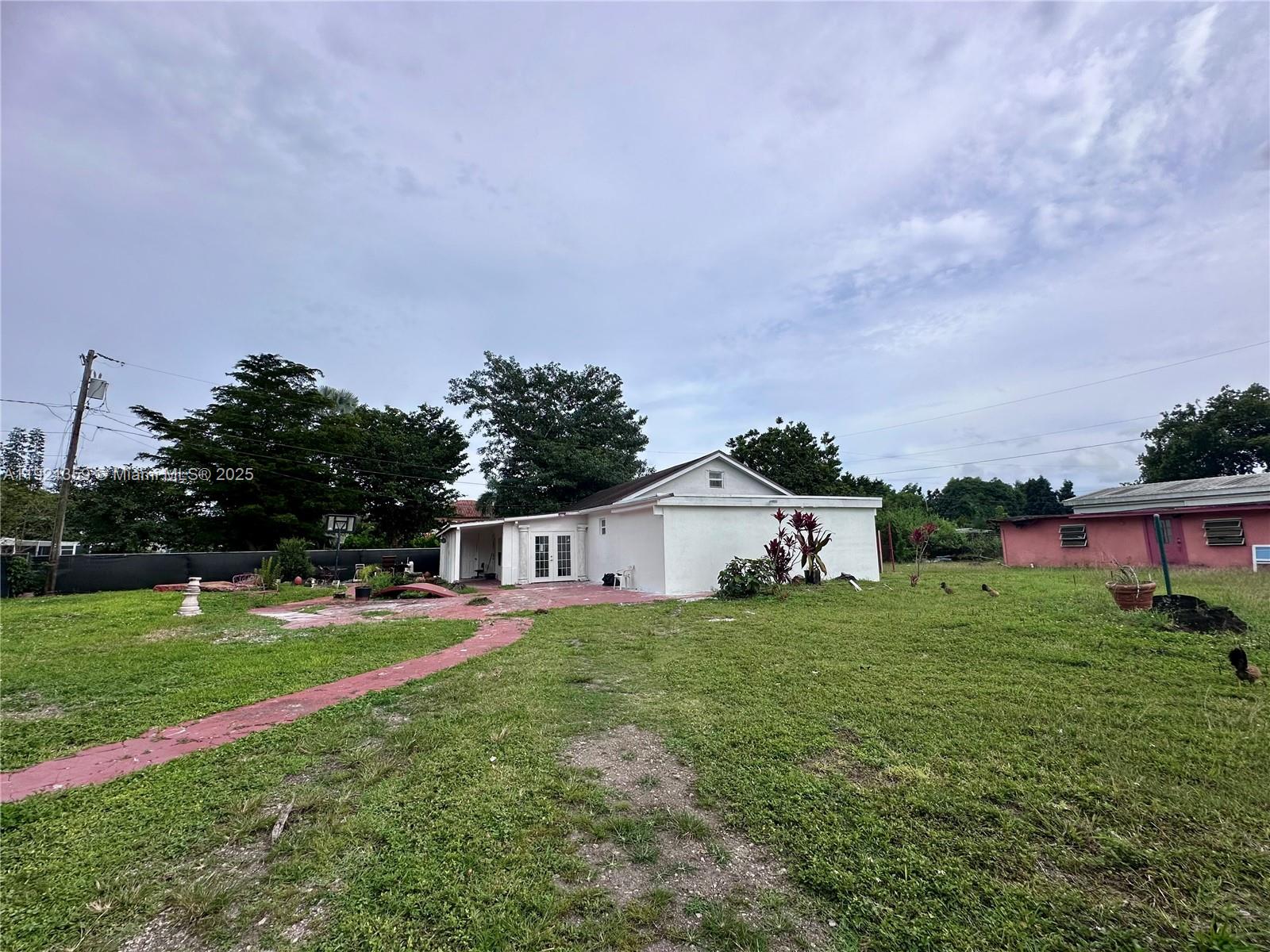 This quiet 2 bed/2 bath gated acre mini farm blends cozy charm with modern upgrades—highlighted by a beautifully remodeled master bath offering a stand-alone tub, stylish design, and a contemporary walk-in shower. The interior is move-in ready, while the exterior offers endless potential for gardens, animals, or custom outdoor living. A versatile third room can function as a bedroom, studio, or income-producing space. 45 min to Key Largo, 1 hour to Miami, you are secluded enough to see the stars every night and hear nothing but the sound of the wind and trees, yet a short drive to Homestead shops, restaurants and entertainment. Full of character and possibility, this property is waiting for new owners (and their pets!) to bring their vision to life. NO HOA, vacant and easy to show! More pictures coming soon!