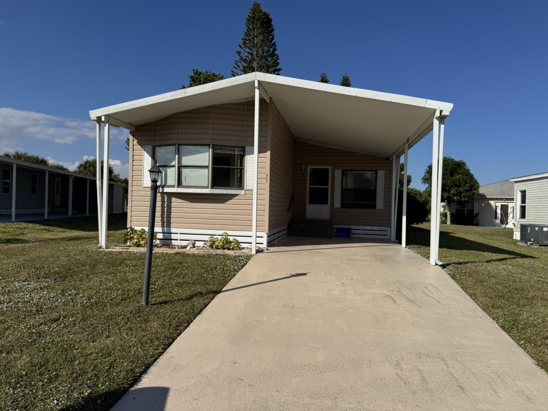 Charming Spanish Lakes Fairways home with a split floor plan 2 bedrooms and bonus room! This park-owned property offers low lot rent of just $699/month. Inside, enjoy modern laminate flooring throughout, a screened-in small patio, and a clean, move-in-ready space. Residents enjoy community amenities including free golf, clubhouse with pool and fitness center, tennis, pickleball, shuffleboard, bocce, and regular social events. Perfect opportunity for affordable, comfortable 55+ living! Close to clubhouse and rec department. Call today to see this one or another park owned home!