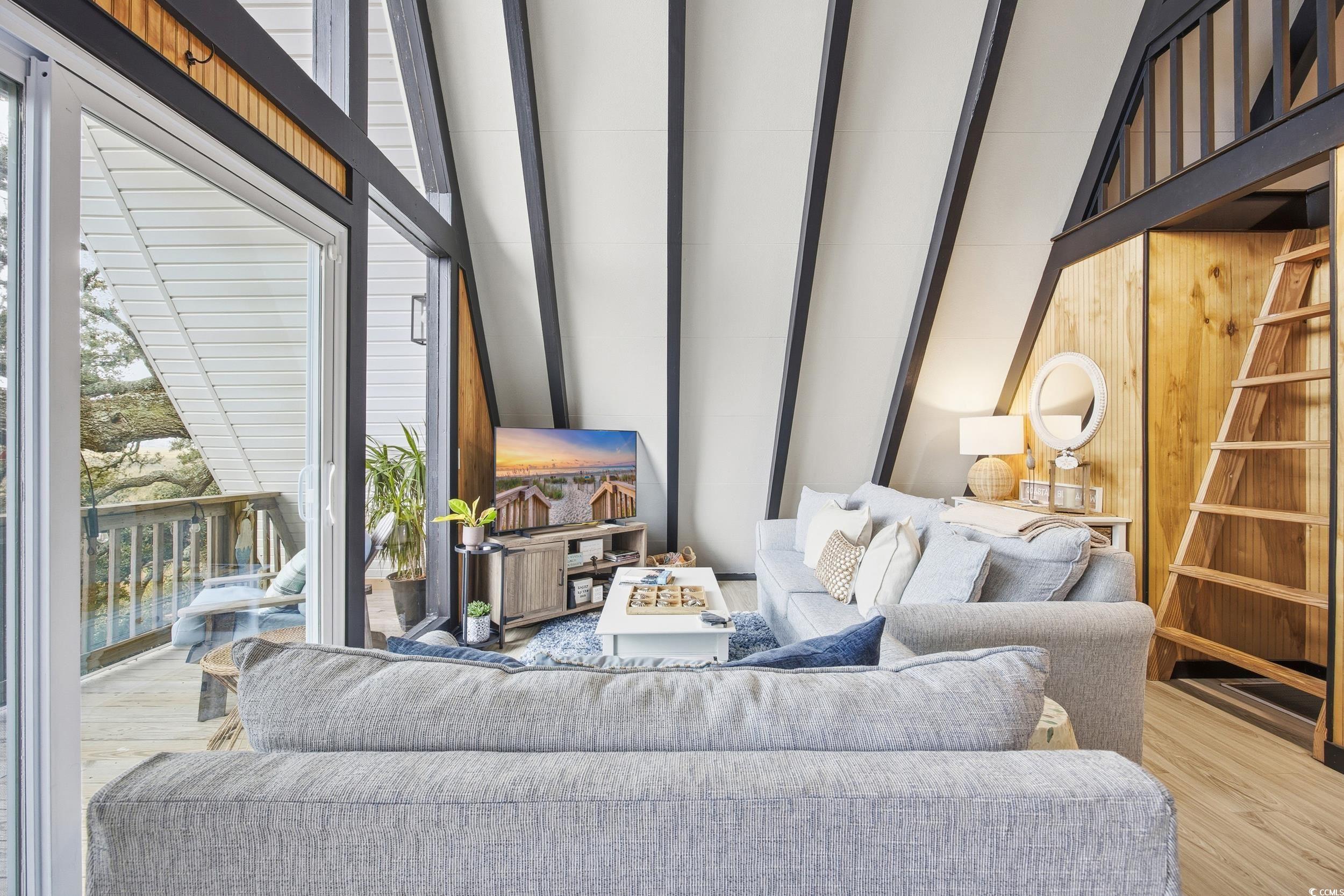 Living room with wood finished floors and wooden walls