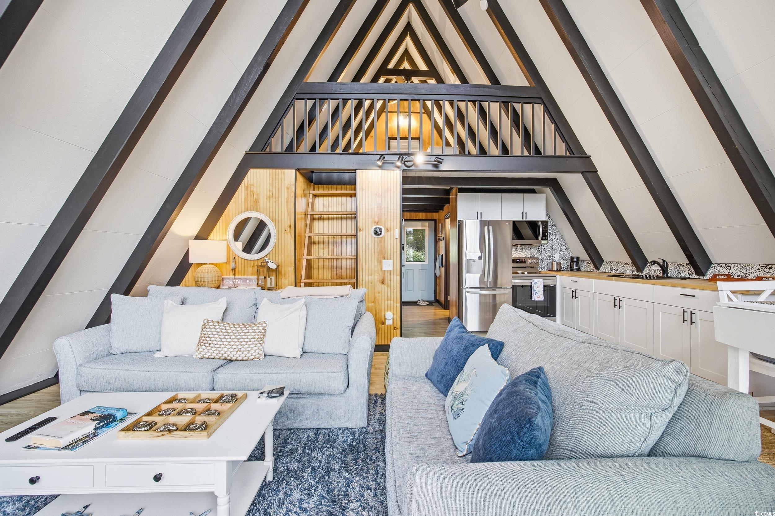Living room with vaulted ceiling and wood finished floors