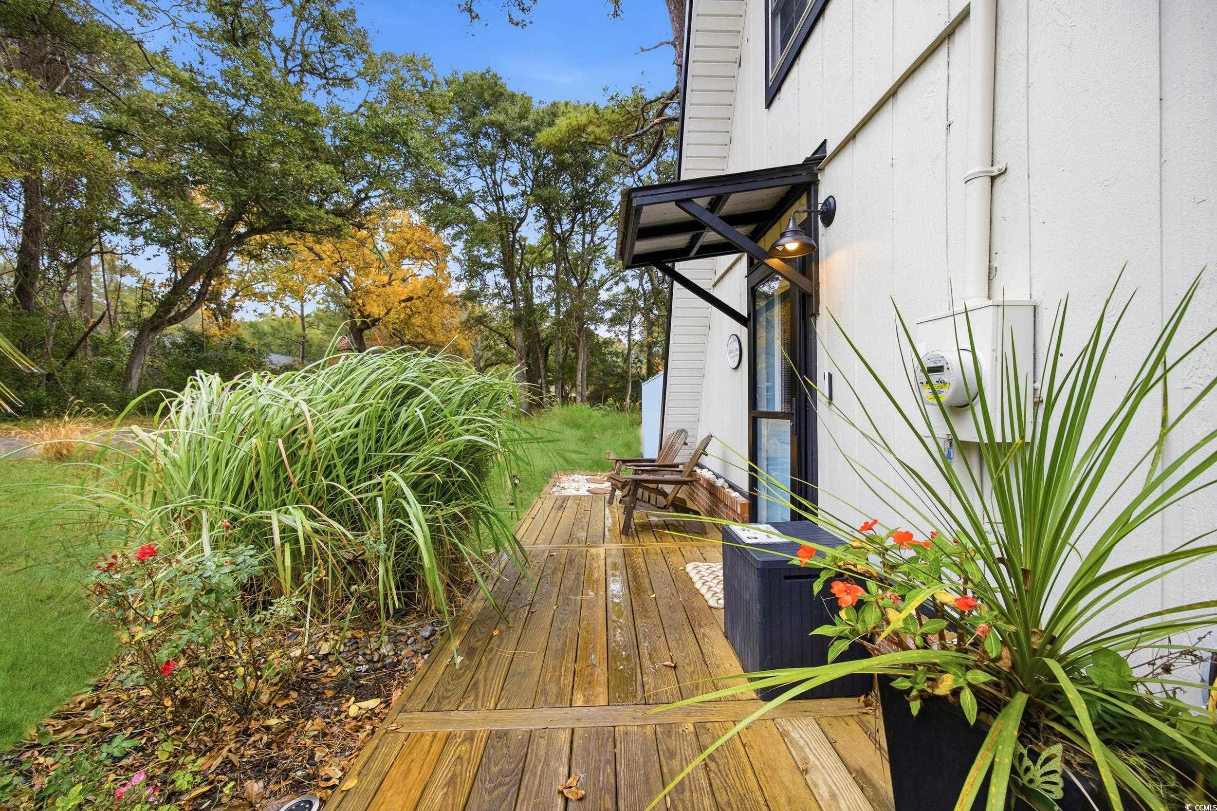 Wooden terrace with view of wooded area
