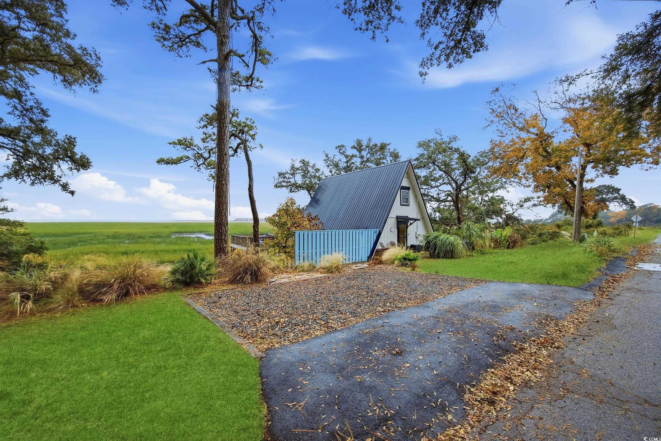 View of green lawn featuring an outdoor structure