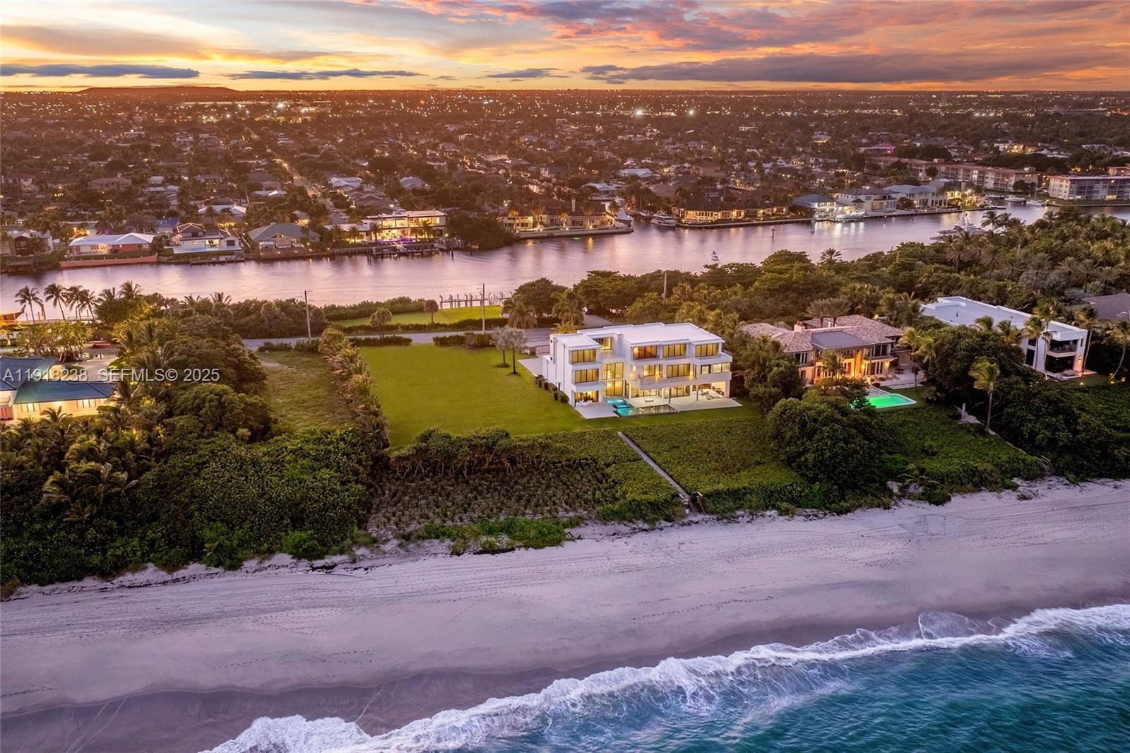 Rising above the Atlantic along Florida’s famed Millionaire’s Mile, this ocean-to-Intracoastal compound is a triumph of scale and sophistication, one of the most significant waterfront estates ever offered in South Florida. Positioned on 2.35 acres with 235 feet of ocean and Intracoastal frontage, this one-of-a-kind asset features a rare full acre of pristine oceanfront land paired with nearly 17,000 square feet of untouched land on the Intracoastal side - offering endless opportunities. This newly upgraded 10,101 sqft residence offers uncompromising attention to detail, elevating beachfront living to a breathtaking new standard. Unfolding across three meticulously curated levels, the property blends timeless elegance with modern craftsmanship. Step into seven generous ensuite bedrooms and eight-and-a-half baths showcasing hand-selected finishes, from Onyx-clad fireplaces and a Crystallo powder room to TOTO Neorest suites, dual laundry rooms, and walls of glass framing endless views of the Atlantic Ocean. Situated 16 feet above sea level, this estate combines beauty with enduring strength. Outside, manicured grounds transition to a resort-style pool and spa, a private beach path, and new seawall and dock. Inside a state-of-the-art home theater and an eight-car showroom garage.This is a legacy property conceived for those who demand the extraordinary. An opportunity to own one of the most iconic oceanfront compounds on South Florida’s most distinguished coastline.