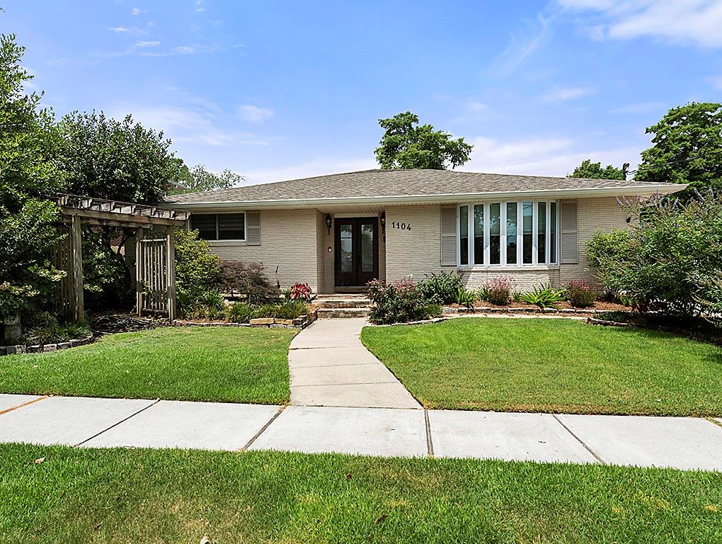 Welcome to this meticulously updated Metairie home, ideally situated on a beautiful tree-lined street below Bonnabel.  The open-concept living, dining, and kitchen area forms the heart of this residence. The kitchen, fully renovated in 2020, boasts new cabinetry and natural quartzite countertops, and a 6-burner Kitchen-Aid range – an entertainer's dream!  The living/dining space is bathed in natural light from a wall of 8-foot windows, with a huge built-in entertainment center ready for up to a 110" TV. Porcelain wood-look tile flows through the main living areas. The master suite is a true retreat. The spacious master bedroom features windows overlooking the pool & deck, a long walk-in closet offers significant storage, and luxury vinyl flooring (2024).  The master bath, completely renovated in 2020, is a spa-like oasis with a giant shower featuring dual controls, dual shower heads, and a marble bench. It also includes an oversized whirlpool tub. Bedroom Suite 2 is bright and spacious with a deep walk-in closet and luxury vinyl flooring.  The en-suite bath has an enclosed glass shower w/ jetted capabilities. Front Bedroom #3 offers a bay window, two closets, a built-in desk/study area, and updated windows (2021). Hall Bedroom #4, used as an office, features luxury vinyl flooring. The hall bath features a marble floor, tub/shower, & linen closet. The hall laundry area has abundant storage options & includes a Maytag Bravos XL washer & gas dryer (2021). The exterior is designed for both enjoyment & security, featuring a 2023 electric gate & covered carport. The backyard is a private paradise with a 4600-gallon semi-permanent in-ground pool & waterfall, Trex decking, & a covered patio, all new in 2023. Plumbing for a future exterior restroom & a 220w access port for an emergency generator are also present. HVAC systems include two separate units (replaced 2021 and 2023) and updated ductwork (2021).  There are too many amenities to list!