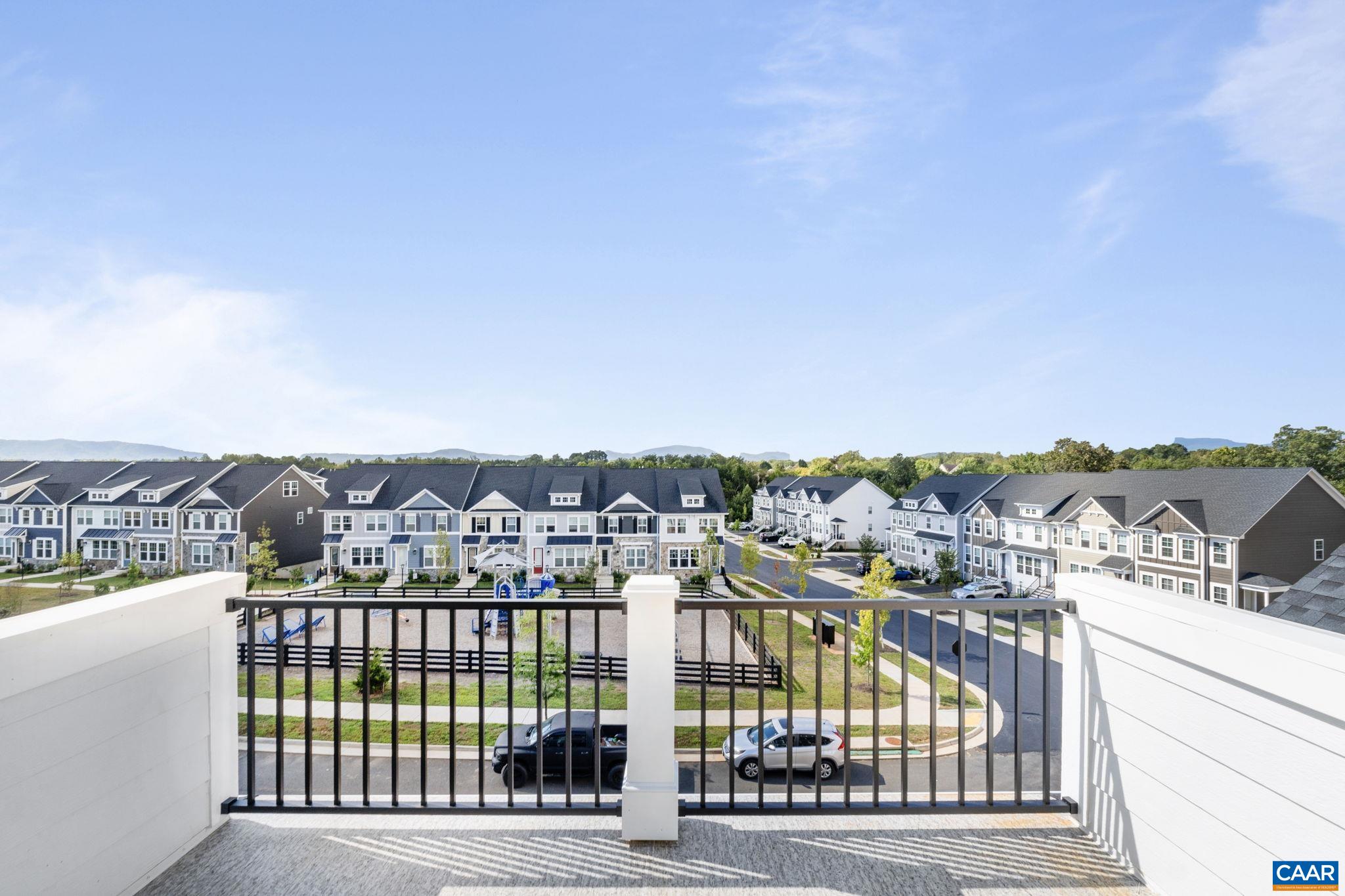 Now complete and ready for move-in, the Poplar II townhome in Glenbrook offers four levels of flexible living surrounded by mountain views, trails, and neighborhood spaces. This interior unit features farmhouse-style architecture with stone accents and a modern, open layout. The main living level includes a spacious kitchen with a walk-in pantry, a light-filled dining area, and access to an elevated rear deck. On the first floor, a private bedroom with an adjacent full bath adds versatility for guests or a home office. Upstairs, three additional bedrooms include a comfortable primary suite. The top level offers a loft and a rooftop terrace with views of the Blue Ridge. A two-car garage, oak stairs, upgraded trim, solid core doors, wood shelving, and energy-efficient systems add thoughtful detail throughout. Actual photos shown! Walkable to Crozet Park with future trail access planned to downtown Crozet.