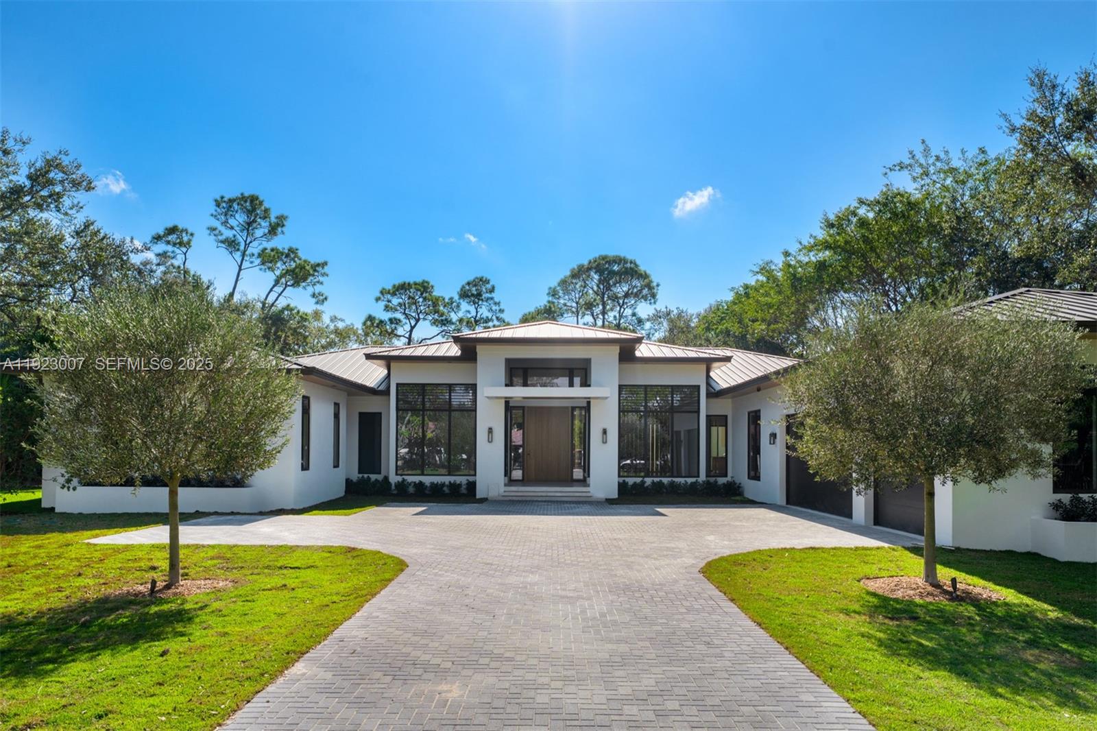 Brand-new construction in Pinecrest, just completed and ready for occupancy. This modern one-story estate on nearly an acre offers 7,760 SF with 7 beds, 7.5 baths, a private guest house with kitchenette, formal dining, media/office, and a gym with steam and sauna. The Pedini kitchen features Subzero and Wolf appliances, plus an outdoor summer kitchen. The grand primary suite has large finished closets and a spa-like bath. A dedicated kids’ wing includes a study area and 3 ensuite bedrooms. Expansive windows, a 3-car garage, resort-style pool, and generous terraces complete this exceptional property near top schools.