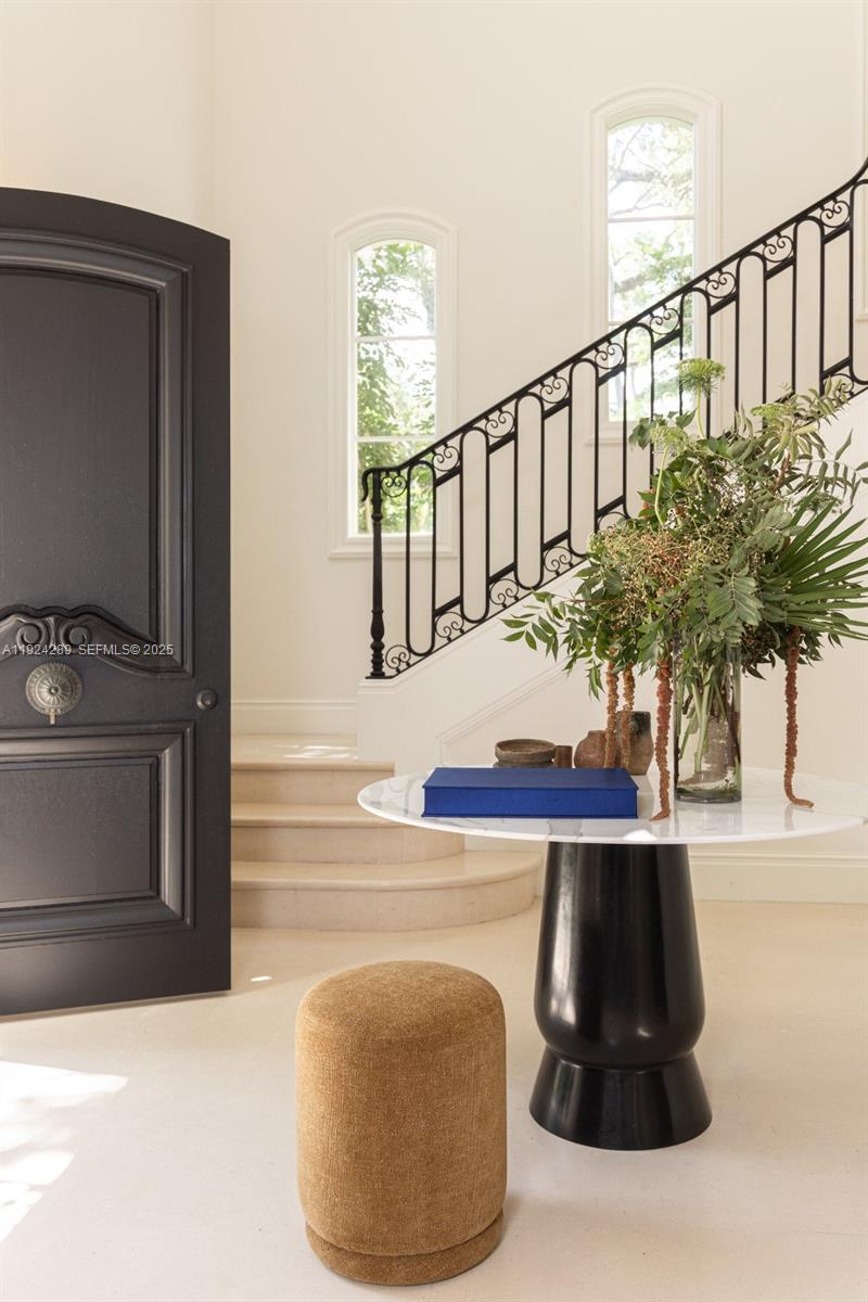 Spectacular, completely remodeled home situated on an oversized lot at the end of a quiet cul-de-sac. This 4-bedroom residence, plus a spacious den/office, offers an exceptional floor plan with vaulted ceilings, impact windows, and a beautiful blend of hardwood and limestone floors. Exquisite finishes are found throughout, including custom built-ins, and refined design details. The eat-in kitchen features top-of-the-line Wolf and Sub-Zero appliances, custom cabinetry, and abundant storage—perfect for both daily living and entertaining.The outdoor living area is equally impressive, with a heated pool, large covered terrace, and lush, mature landscaping creating a serene and private retreat. 5,420 adjusted square feet per appraiser. Ideally located in South Grove, just minutes from top schools, Coral Gables, Coconut Grove, boutique shops, and premier dining.