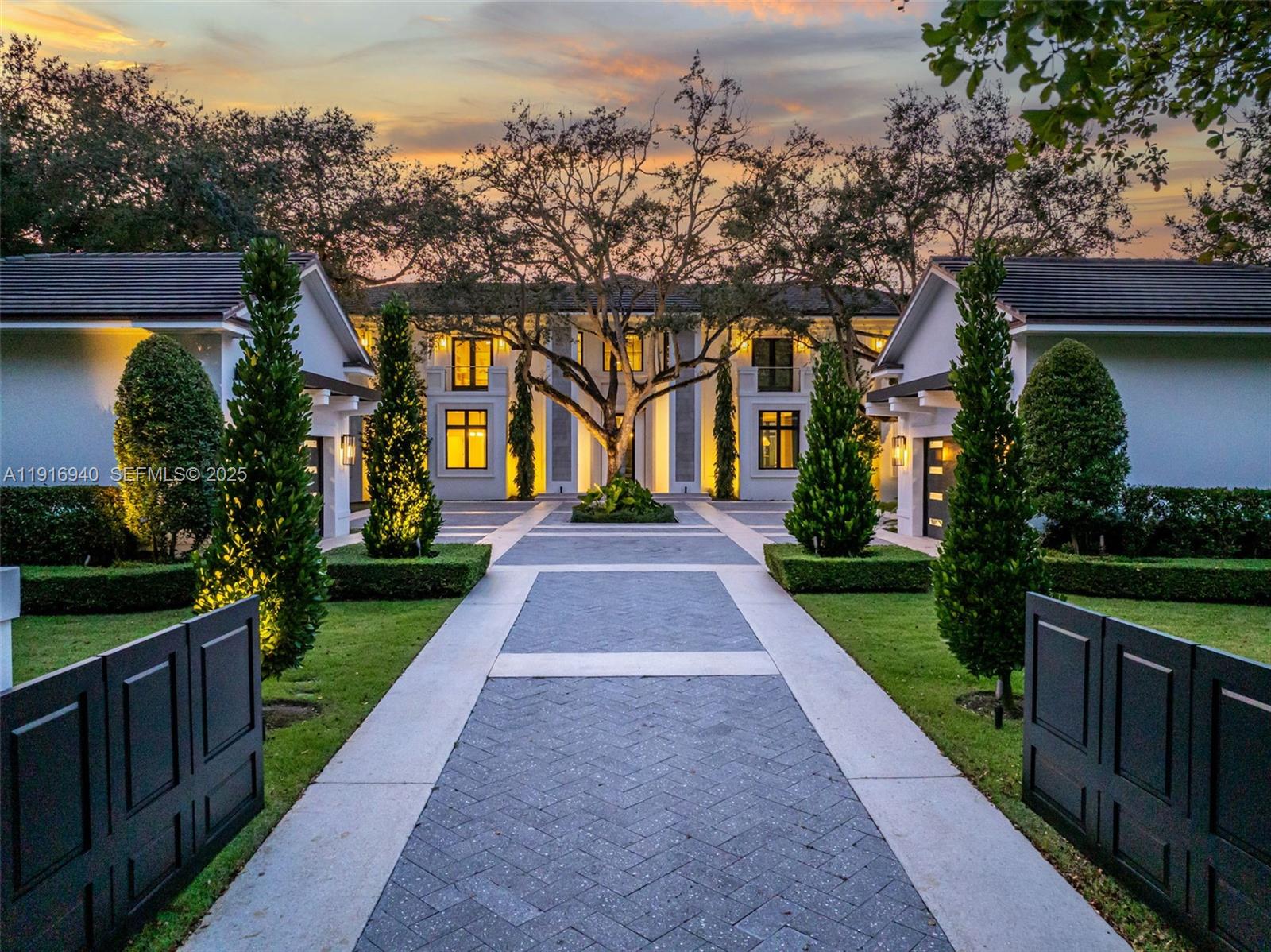 Never-before-seen, recently built, exquisitely designed 2-story Estate on a quiet, oak-lined street in North Pinecrest. Contemporary & timeless, grandly scaled & understated. No-expense-spared finishes include gorgeous natural stone & wood floors throughout, extraordinary vaulted ceilings, bespoke millwork. Abundant windows complement expansive, thoughtfully appointed space: 7 bedrooms (4 up), 6.5 baths, living, family & formal dining rooms, eat-in kitchen w/ Subzero & Wolf appliances, theater, game & play rooms, gym, 2 laundry rooms (up/down), 4-car garage. Smart Home w/ Savant-Sonos-powered security. Exterior features: Screened summer kitchen, lavish resort pool, lit basketball court, playground, lush landscape & full-house generator. This custom-curated Pinecrest Paradise has it all!