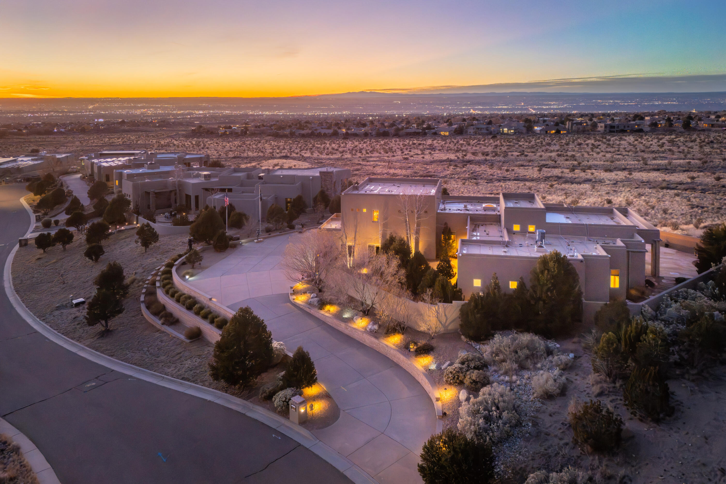 Beautifully updated custom home in High Desert, showcasing breathtaking views of the Sandia Mountains and the city lights of Albuquerque from a premier estate lot backing to dedicated open space. Enjoy immediate access to miles of hiking and walking trails right outside your door. Luxury finishes include hand-troweled plaster walls, solid wood doors and windows, beamed ceilings, designer lighting, hardwood and porcelain tile flooring, and two fireplaces. The kitchen has been exquisitely remodeled with handcrafted cabinetry, Wolf and Sub-Zero appliances, rich granite, and a stunning live-edge island. All bedrooms offer en-suite bathrooms and walk-in closets. Spectacular landscaping with flagstone patios, a tranquil fountain, and mature plantings create exceptional spaces for outdoor living