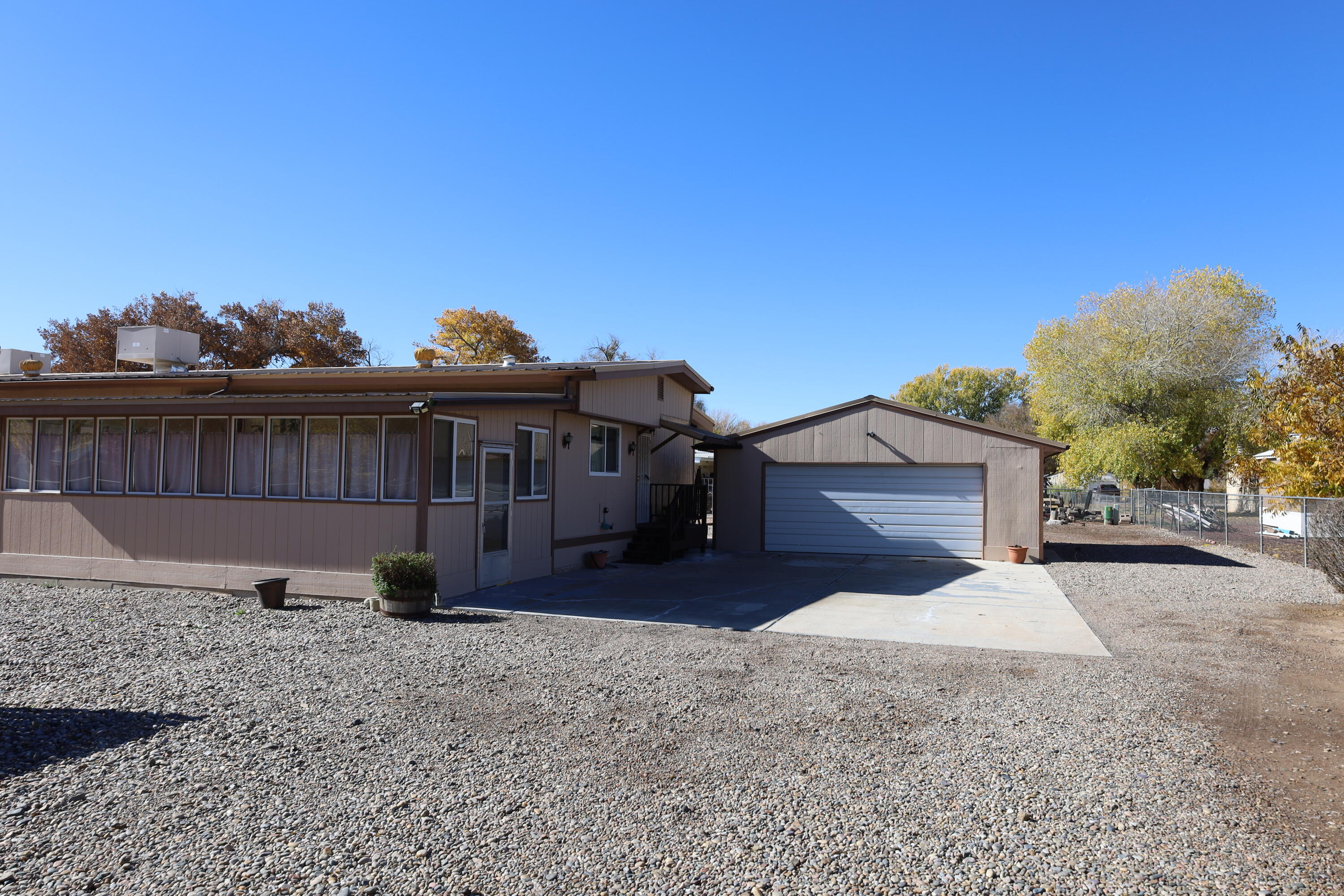 What a nice property! This home has been beautifully maintained and improved. Lots of great features! Solar powered entry gate, 2-car detached garage, easy maintenance half-acre lot. Beautiful living room and primary bedroom suite addition. Home has two living areas, three bathrooms, and a large sunroom. Tons of updates...per seller: metal roof about 8yrs old, gas log fireplace 4 yrs old, windows about 8 yrs old, both evap coolers 4 yrs old, H2O heater 6 yrs old, new gutters in 2024, New fridge, hard surface counters in kit. 6 years old,...Lots of room for your family to enjoy. Come show it. You will not be disappointed! Realtors, please read LO/SO before showing.
