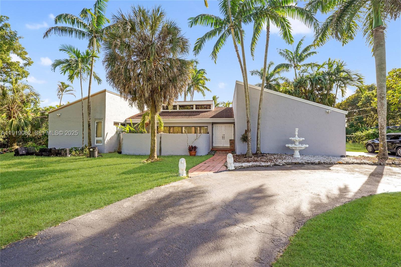 Exceptional home in a great location at an outstanding price. This spacious residence offers 4 bedrooms, 2 and 1/2 bathrooms, and an attached 2-car garage, situated on an expansive 42,035 SF corner lot. The home features generous living areas filled with natural light, including formal living and dining rooms that overlook the pool and patio.The large eat-in kitchen flows seamlessly into a comfortable family room, currently set up as a home theater. The fully fenced property is ideal for both privacy and entertaining, complete with a sparkling pool, Tiki hut, children’s play area, and a covered terrace. Convenient circular driveway provides ample parking, with plenty of room for a boat or RV.Located close to major roadways, schools, entertainment, and more—this home is a must-see and should be at the top of your list.