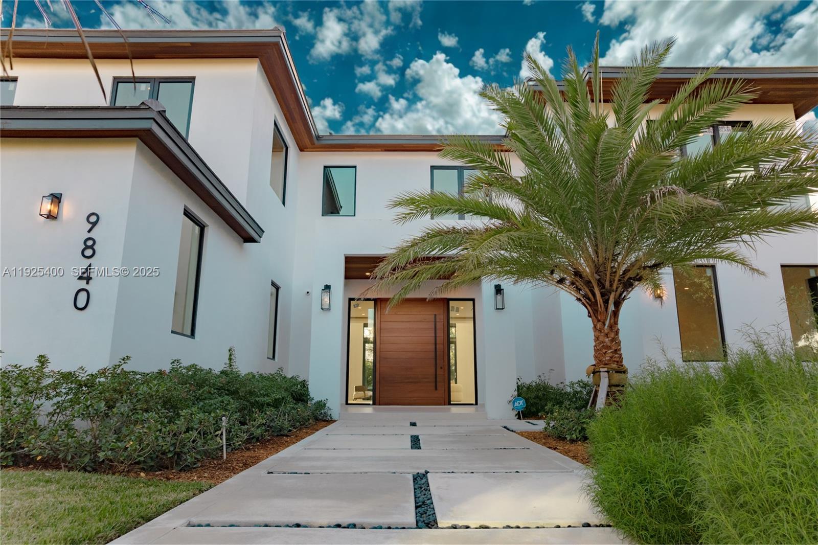 New Construction 2025. Experience Pinecrest living at its finest in this classic-with-a-modern-twist masterpiece, offering 8,143 sq. ft. of total construction and 6,841 sq. ft. under A/C. Perfectly positioned on a 15,225 sq. ft. corner lot, this 6-bed, 7.5-bath luxury residence was designed for those who appreciate sophisticated craftsmanship, elevated design, and effortless indoor–outdoor living. Step into a home bathed in natural light, enhanced by expansive windows and double-height panoramic views in the main living room. The open layout is complemented by a chef-inspired kitchen featuring top-tier luxury appliances, wolf and subzero, an oversized island, and a walk-in pantry. The resort-style backyard offers a sparkling saltwater pool, heated spa/jacuzzi, sun-drenched terraces, and generous outdoor areas ideal for entertaining. A car enthusiast’s dream, the property includes a 3-car garage with lift capability plus an additional 11-car driveway capacity. Retreat to the massive primary suite, a true sanctuary with a spa-inspired bathroom featuring a wet room, dual vanities, and a spectacular custom oversized closet that feels like its own boutique. Each Suite offers ample space, en-suite bathrooms. Every detail was thoughtfully curated, including the integration of Valentina Bilbao’s fine art, perfectly complementing the home's architectural elegance. A rare opportunity to own a brand-new luxury residence in one of Pinecrest’s best location.