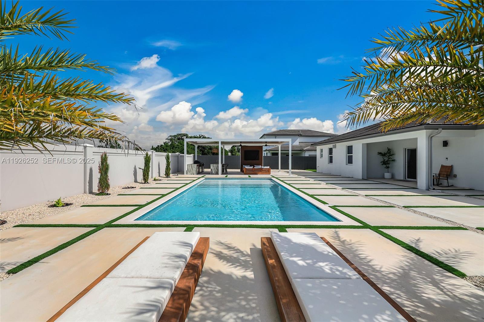 Private modern home upgraded inside and out. This 2023 newly built home features a fully decked backyard, resort-style saltwater pool, landscape lighting, high-end outdoor kitchen under an aluminum pergola, and more. Inside, every room offers custom walk-in closets, upgraded floors, a conditioned two-car garage with epoxy, full security system with cameras, alarm, city water and sewer (no septic), and other additional upgrades. The property sits on an no flood zone oversized 13,000+ sqft lot with space on both sides for a boat or RV, no back neighbors. Bright, private, No Hoa, move-in ready, and built for the lifestyle everyone wants but rarely finds.