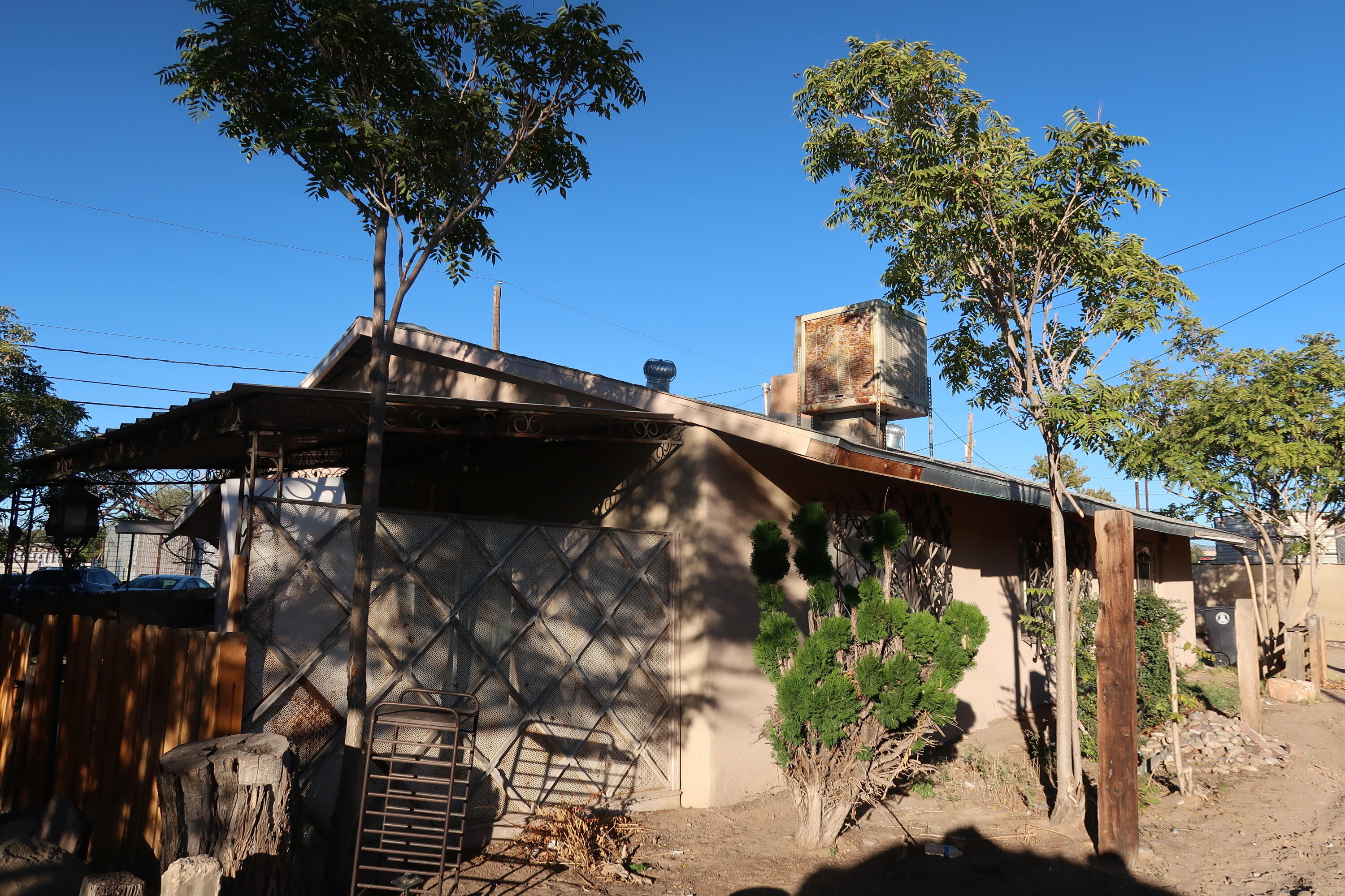 Discover this versatile property featuring 2 separate dwellings on one lot, located in the southeast side of Albuquerque. With a combined total of 5 bedrooms and 2 baths, this setup is ideal for investors or multi-generational living.The primary dwelling offers generous living space, while the secondary dwelling provides additional flexibility as a guest house, rental unit, or workspace. The property does require some care and updating, making it a perfect opportunity for those looking to add value and customize to their vision.