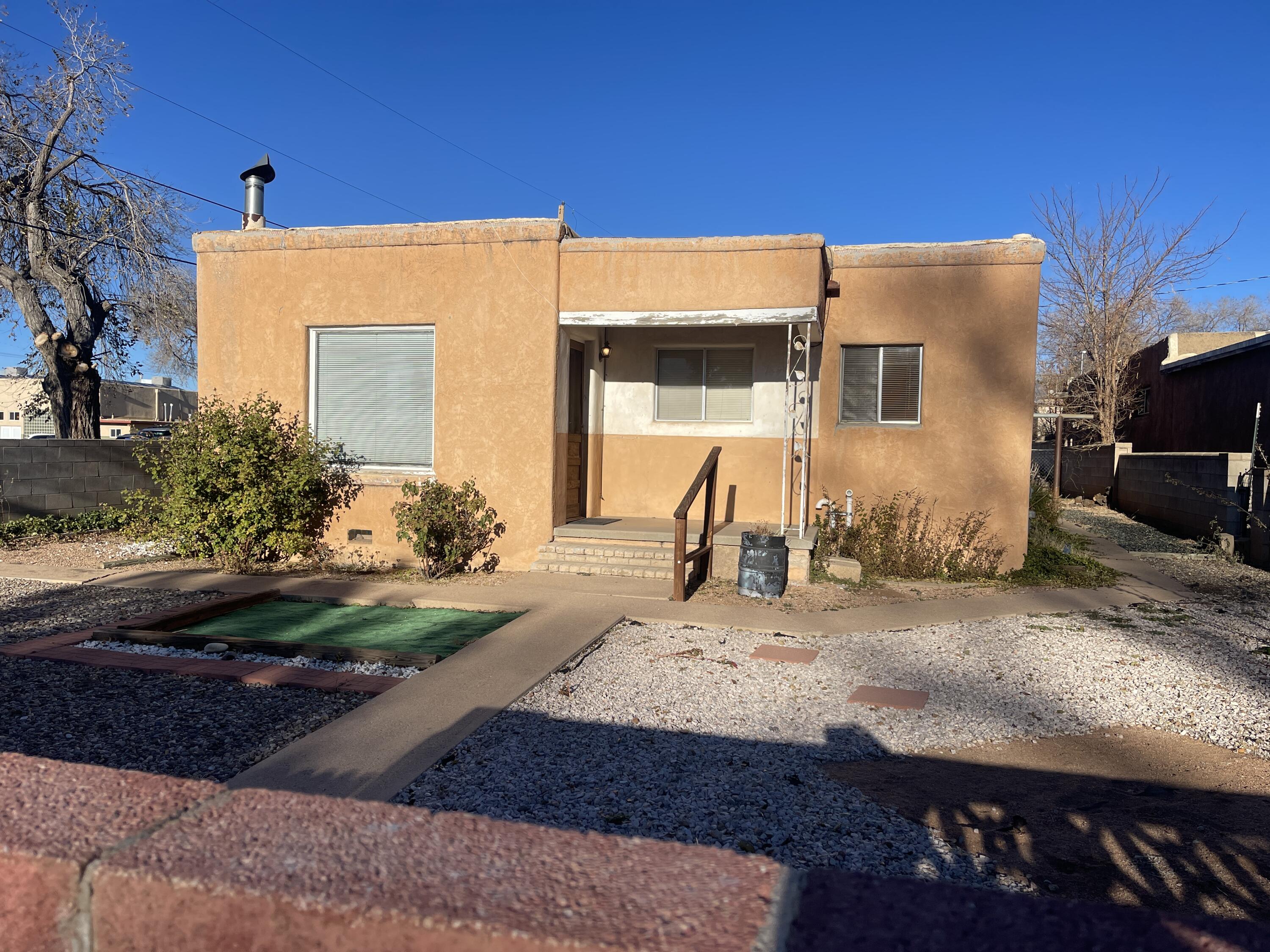 Great opportunity to put your own touch on this Charming Santa Fe Home ! Kiva Fireplace, Hardwood floors, Nichos and nice built ins!  Side/Back yard access possible! Nice location across from Young Park ! Handy man special! Priced to sell, Hurry!