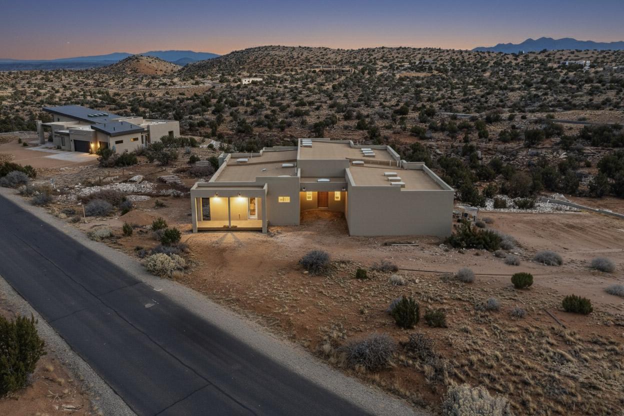 Welcome to this luxury new-build in the exclusive gated Diamond Tail Estates of Placitas. This spacious high end 3 bed, 3 bath home sits on 2 acres with stunning views in every direction. Built with metal framing and aircrete exterior for superior insulation plus fire and moisture resistance. Features include a chef's kitchen with all appliances, pass-through bar window to the outside, beer tap, and wine cooler, plus a continuous large-capacity hot water heater. Enjoy an open-concept design with skylights, abundant natural light, luxury hardwood floors, and a home sound system. The oversized 3-car garage is ideal for storage or workshop use. Outdoor perks include a gas stub, fire pit, and potential swim spa. Buyers under contract during construction may be able to choose select finishes.