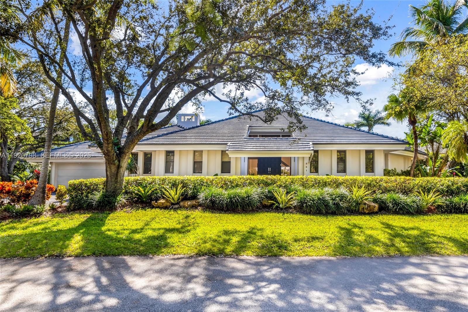 This elegant residence is situated within the prestigious, guard-gated community of Cocoplum, one of South Florida’s most sought-after neighborhoods. The home boasts a formal living and dining room, along with a beautiful modern eat-in kitchen featuring granite countertops, stainless steel appliances, wood cabinetry, and a breakfast nook overlooking the covered terrace and pool area. All social spaces are finished with marble flooring and the bathrooms have been tastefully updated. The layout includes three bedrooms on the first floor, including the spacious master suite, with an additional guest bedroom located upstairs. The property also offers a generous circular driveway and a two-car garage