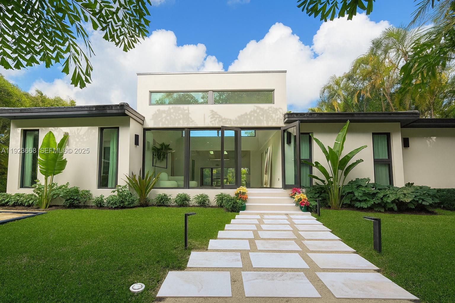 Recently fully renovated and reimagined with a complete modern transformation, this exceptional 3,100 SF residence is positioned on an elevated 16,800 SF double lot with 113 feet of direct water frontage along one of Belle Meade’s deepest and widest canals, with minimal traffic, and enhanced privacy with no fixed bridges to Biscayne Bay. Designed for elevated indoor–outdoor living, the home features soaring ceilings, a desirable split-bedroom layout for privacy, and seamless flow ideal for entertaining. Interiors showcase a gourmet Miele chef’s kitchen, custom millwork, premium finishes, Lutron HomeWorks smart lighting, whole home audio, UniFi networking, motorized window treatments, and abundant skylights that flood the home with natural light.The 750 SF primary suite offers a true retreat with spa-style bath, steam shower, soaking tub, and designer stone finishes, complemented by a 225 SF custom walk-in closet with bespoke cabinetry, LED lighting, integrated sound, center island, and skylight illumination. Ideal for boating enthusiasts, the property provides direct bay access, shore power at the seawall, and an expansive yard perfect for entertaining. The grounds feature a full bocce court, lush privacy landscaping, and ample space for a future pool or expansion. Centrally located with top private schools including The Cushman School and Miami Country Day School. A rare opportunity to acquire a turnkey estate offering privacy, scale, and immediate Biscayne Bay access.