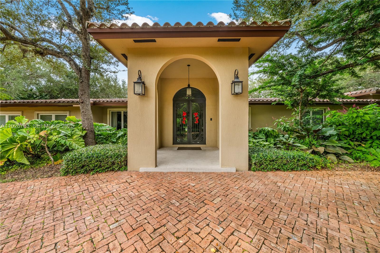 This North Pinecrest Gem has been tastefully updated and is beautifully positioned on this spectacular, oak studded lot! Enter through wrought iron gates to a Chicago brick circular driveway. Gracious entry way flows into an open floor plan, a magnificent kitchen with walnut cabinetry and top of the line appliances. The deep covered terrace is perfect for entertaining, overlooking a spectacular heated pool. The primary suite features 2 walk in closets and sumptuous bathroom which also opens onto pool. There is a spacious room which could be used as a 6th bedroom or office.So much space on either side of this gracious home to expand if desired.Bring your most discerning Clients!