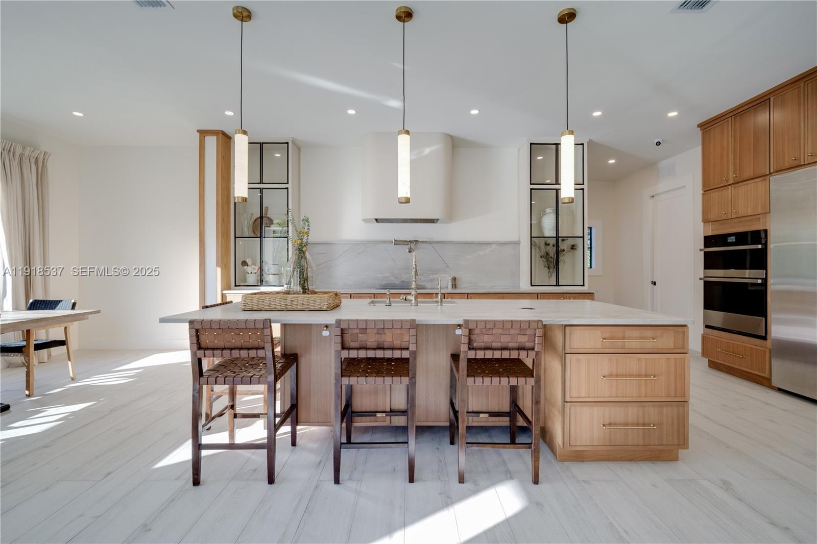 3,932 square feet of pure living area! (More than tax roll) Imagine coming home to a warm-modern 6-bed, 6-bath home on a private 29,000 sqft lot, straight out of a Pinterest board. Completely redesigned and remodeled, this home has everything you could want! The chef's kitchen features custom wood cabinetry with brass accents, a curved industrial-scale hood, leathered stone, luxury appliances and a butler's pantry right behind perfect for any soiree! The primary suite is a serene retreat comprised of beautiful millwork, his and hers California closets, french doors to the pool area and a spa-inspired bath. The split layout conveniently includes 4 beds and 3 baths on one end of the house while the other wing includes the office room, playroom/den and private bedroom suite ideal for guests. Impact and UV-filtered windows/doors fill the home with natural light while keeping it private and secure. Integrated sound system throughout the home and terrace make for effortless gatherings. Outside you'll find the refreshed pool, lush landscaping, convenient cabana bath and expansive yard with room to build the court of your dreams. 2 car garage for ample storage and large circular driveway. Updated plumbing and electrical. Sits on a quiet U street providing extra privacy. Come experience Palmetto Bay living! Move in ready... just bring your golf cart!