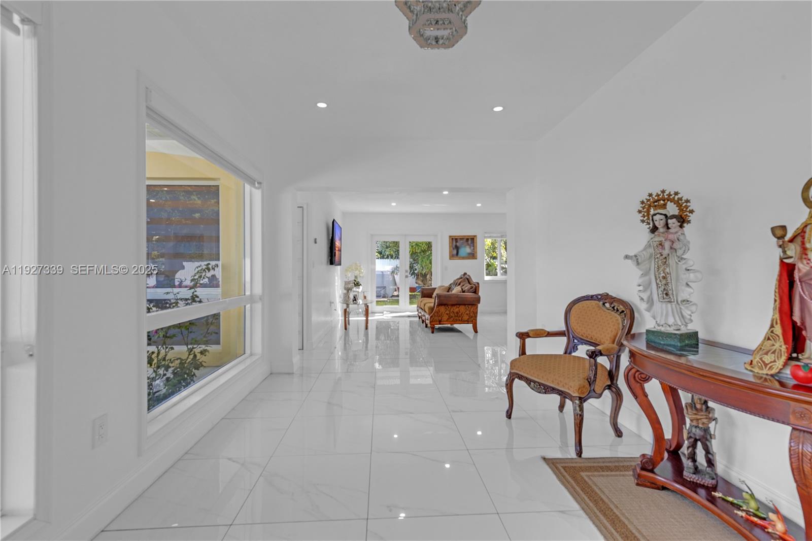 Discover this exceptional 5-bedroom, 5-bath estate located in highly desirable South Dade. Set on a beautifully maintained lot, this residence offers impact windows and doors, electric garage doors, and comprehensive security with an electric perimeter fence, automatic gate, and full aluminum fencing around the property. Enjoy added peace of mind with 3 new A/C units, 2 septic tanks, a full sprinkler system, and a whole-home water filtration system.The outdoor spaces are truly impressive, featuring a covered terrace, electric front-porch shades, abundant yard space ideal for entertaining, and more than 23 mature fruit trees. A separate guest house provides flexible living options and includes its own office, making it perfect for work, visitors, or extended stays.