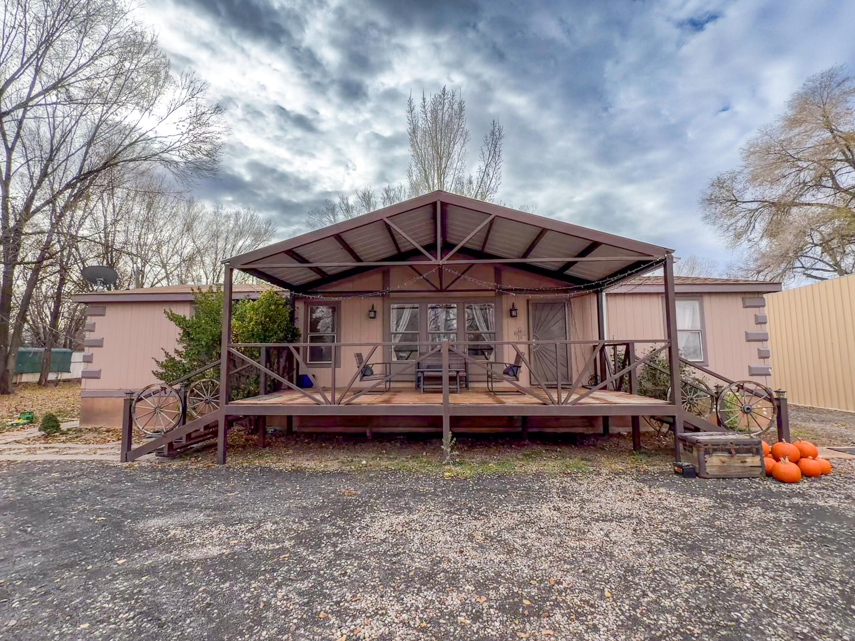 Charming 3-bed, 2-bath home on just under 1 acre in Belen! This split floor plan features a spacious primary suite with garden tub, separate shower, dual sinks, and a bonus flex room ideal for an office, sitting area, or craft space. Outside, enjoy a fully fenced lot with mature fruit trees (plum, apple, cherry), grape vines, and a peaceful pond with koi and goldfish. Property includes a 2-car garage/workshop with 220V power, one door tall enough for potential RV parking, plus a 2-car carport. Possible MRGCD ditch irrigation rights. A great blend of comfort, space, and versatility!