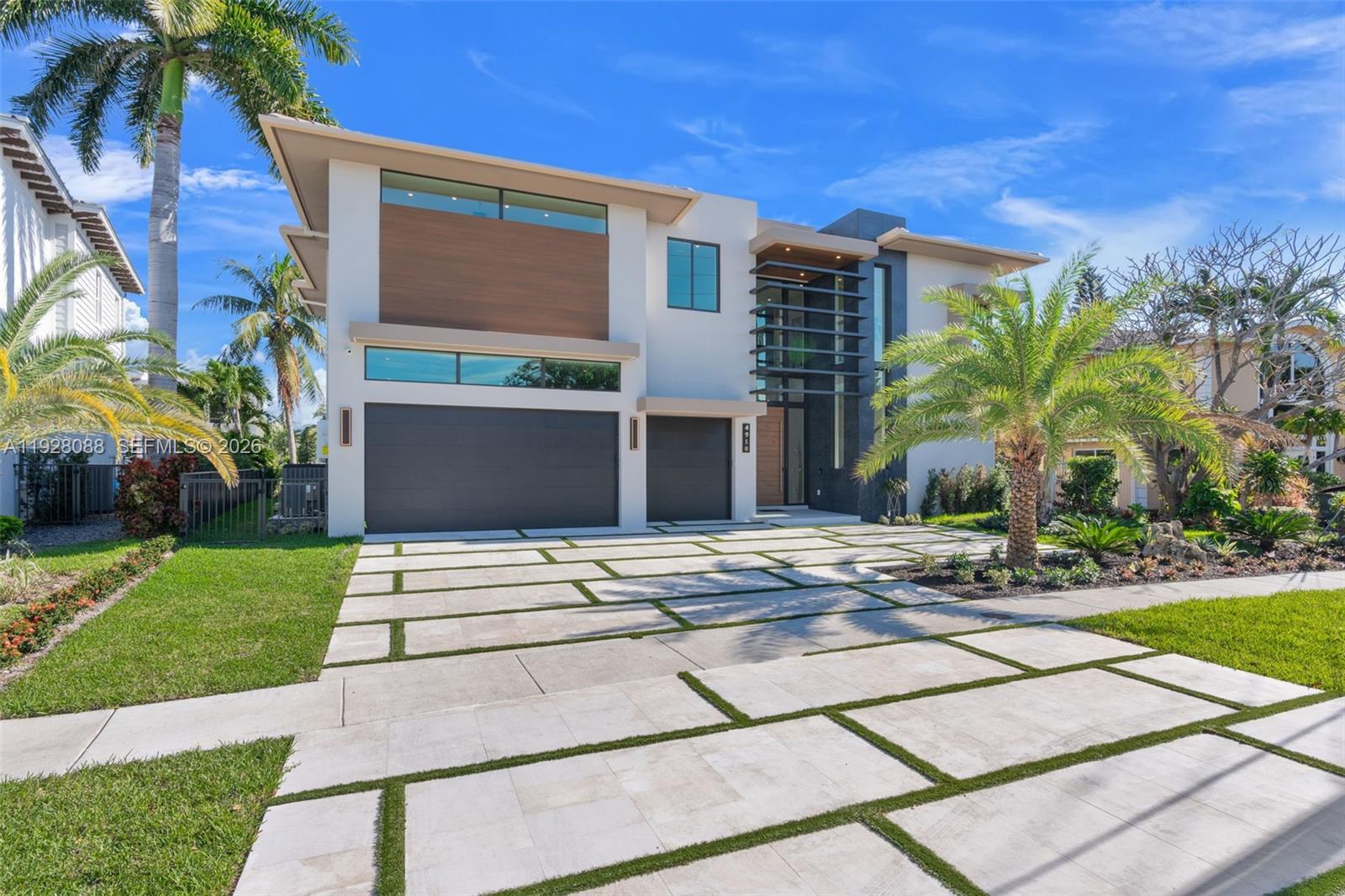 Introducing a spectacular 2026 modern waterfront estate in the heart of Lighthouse Point, offering exceptional design, premium finishes, and true resort-style living. This 5-bedroom, 6-bath residence spans 5,055 sq ft (5,961 total) and sits on 90 feet of deepwater frontage with direct ocean access—ideal for luxury coastal living. Step inside to soaring 12-foot ceilings, open living areas, and a sleek contemporary layout filled with natural light. Impact glass pocket doors disappear, creating a dramatic indoor–outdoor flow to the waterfront terrace. The chef’s kitchen is a showpiece, featuring Sub-Zero and Wolf appliances, custom cabinetry, and an exquisite sculptural island that anchors the home’s sophisticated entertaining spaces.A curated blend of imported Italian and Spanish designer finishes add modern grandeur throughout. The primary suite is a private sanctuary with water views, a spa-inspired bath, and boutique-style closets. Guest suites are spacious and elegantly appointed. A private elevator, smart-home integration, and impeccable 2026 construction ensure seamless, elevated living.Outside, enjoy a resort-style pool, covered terraces, and a private dock ready for a large vessel. This brand-new residence blends a rare fusion of bold architecture, cutting-edge design, luxury detail, with the best of South Florida waterfront living—an exceptional opportunity in one of Lighthouse Point’s most coveted neighbourhoods.