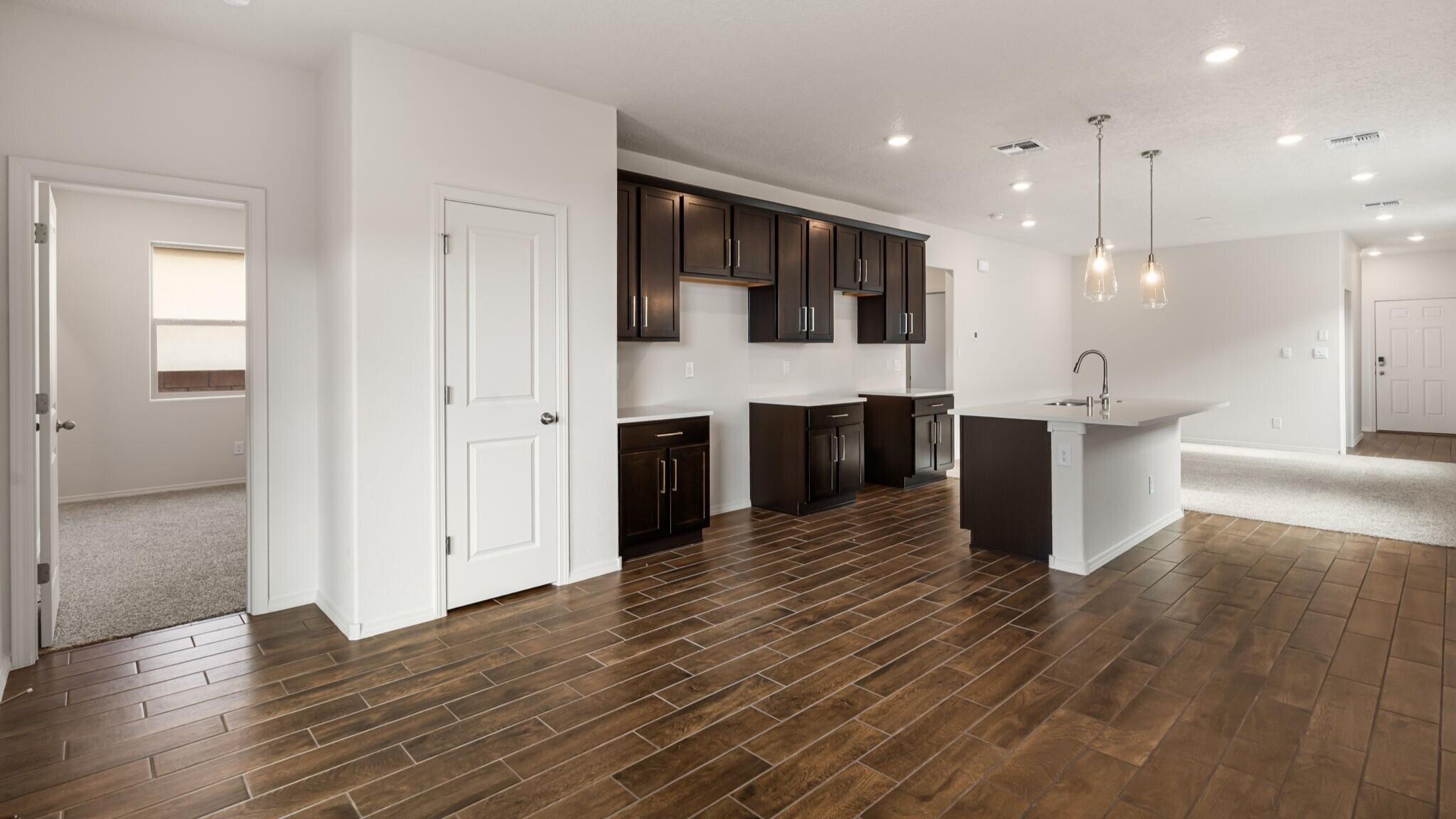 Welcome to this stunning new-construction home set within a secure, gated community! This beautifully designed 3-bedroom, 2-bath residence offers 1,420 sq. ft. of modern living space with an inviting open-concept floorplan ideal for both everyday comfort and effortless entertaining. Step inside to find bright, airy living areas that flow seamlessly from the spacious great room to the contemporary kitchen and dining space. The thoughtful layout maximizes natural light and creates a warm, welcoming atmosphere throughout. The private primary suite features ample closet space and a well-appointed bathroom, while two additional bedrooms provide flexibility for family, guests, or a home office.